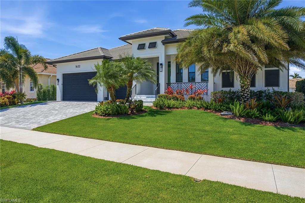 Experience exceptional waterfront living and resort-style comfort on Marco Island. Boating enthusiasts will appreciate the expansive dock complete with two 12,000-pound boat lifts, including a boat canopy, fish cleaning station, and water and electric service at the dock. The property also features the seawall that was replaced in 2018, offering added value and peace of mind. Enjoy a short boat ride to the Gulf with easy access to open-water adventures. This thoughtfully designed residence offers four bedrooms, three full baths, one half bath and an extra-high, air-conditioned three-car garage complete with an installed car lift to accommodate an additional vehicle. Elegant finishes and abundant natural light enhance the home throughout. A 1,000-pound propane tank services the gas cooktop, generator, outdoor kitchen, pool heater, dryer, and tankless water heater, providing convenience and efficiency for everyday living and entertaining. The expansive kitchen is designed for everyday living and entertaining. It features recessed lighting, custom cabinetry, glass-inlay cabinetry, a hidden walk-in pantry, an expansive island with seating, and premium appliances, including a wall oven, gas cooktop, dishwasher, refrigerator/freezer with icemaker, wine cooler, and standalone ice maker. The kitchen flows effortlessly into the dining area, creating an open and inviting gathering space. Porcelain tile flows throughout the home, creating a clean and sophisticated feel. The spacious living room showcases high tray ceilings with shiplap detail, an electric fireplace, and sliding glass doors that seamlessly open to the outdoor living spaces for Florida indoor-outdoor living. The primary suite offers a peaceful retreat with bright natural light, plantation shutters and a ceiling fan. The luxurious en-suite bath features an oversized walk-in glass shower with multiple shower heads, a separate soaking tub, dual sinks and spacious dual walk-in closets. The expansive screened lanai, featuring rich marble tile, creates the ultimate outdoor retreat with covered living space, ceiling fans, electric storm screens, a pool bath, outdoor shower, and a fully equipped outdoor kitchen featuring a built-in grill, flattop and beverage refrigerator. The resort-style pool features a spa and sun shelf, all overlooking the waterfront setting and providing space for entertaining or relaxing year-round. Impact doors and windows provide valuable storm protection and peace of mind. Ideally near Marco Island’s renowned dining, shopping, entertainment and white-sand Gulf beaches, this exceptional waterfront residence offers the ideal blend of luxury, comfort and coastal living.