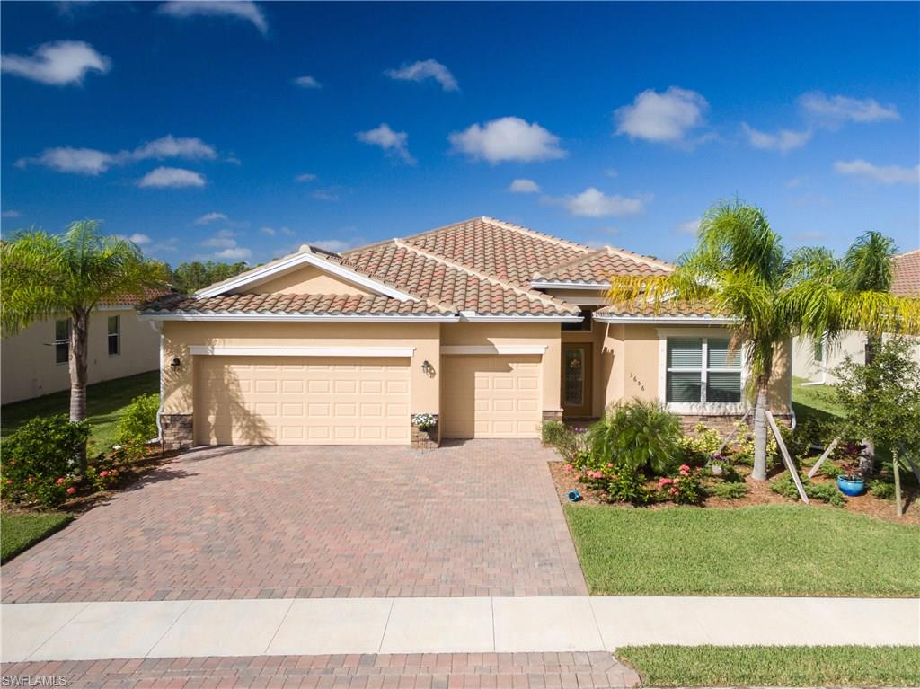 This wonderful and spacious 4 bedroom, 3 bathroom, 3 car garage home built in 2016 is waiting for you! Situated in the rear of Bella Vida - an enclave of single family homes, as well as Townhomes- this executive style home offers luxurious space that will cater to your lifestyle needs.  The large eat-in kitchen boasts stainless steel appliances, granite counters, large pantry, and plenty of space for the cook.  With a large dining room and living room combining to make this an open living area, this home is perfect for entertaining, and comfortable living. Master en-suite overlooks the lake, and features a large walk-in closet, garden tub, step in shower, and dual vanities.  Bedroom 2 & 3 share a full bath, while bedroom 4 is a junior master that is perfect for guests, or multi-generation living.  Flooring throughout is a pleasant blend of hardwood, porcelain tile, and carpet. Bella Vida offers a clubhouse, with a gym, pool, spa, tennis courts, and a comfort area.   There is also a community playground that offers a wonderful day out for all.  Just 15 minutes from downtown Ft. Myers, 20 min from Punta Gorda, this exclusive home is the LAST 3 car garage home available in Bella Vida.
