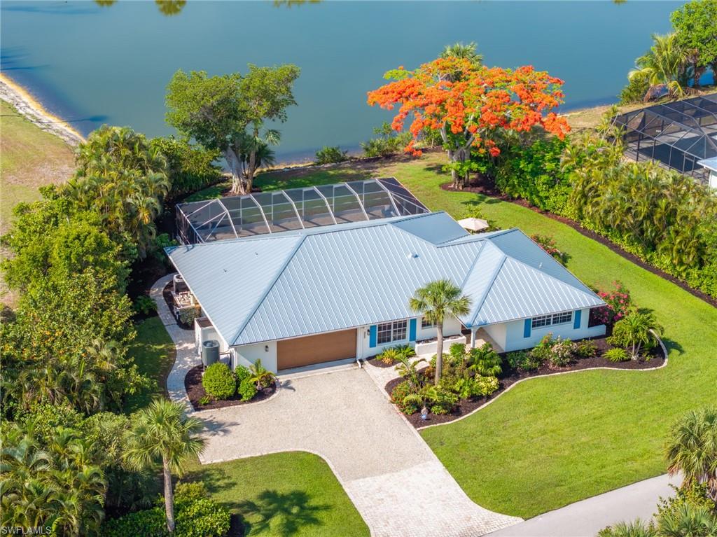 Let us take you for a tour of this designer inspired open-floor plan, stair-free, light and bright home. This gorgeous home features 3 bedrooms, 2 baths plus bonus room/den with panoramic views of Palm Lake and includes a deeded beach access to the Gulf. Spacious and comfortable living room space with vaulted ceiling opening to a sleek and functional kitchen with double door stainless refrigerator/freezer, sleek flat-top stovetop and oven, white Marble countertop with white cabinetry and not to mention the pool and Lake views. Beyond the kitchen nook is the open pantry which serves as a coffee or wine bar offering an additional sink, microwave and wine cooler designed with wall of cabinets from floor to ceiling. A wow layout!
Enjoy the lake views from sunrise to sunset from your newer heated spa and pool with stylish pool screen enclosure
An outside paved patio surrounds you with beautiful grounds with mature vegetation.
Back inside, the Primary bedroom has an en-suite bathroom with double sinks and glass enclosed shower. Off this bedroom is a flex space which can serve as a media room, den or office area. All bedrooms have room defining carpeting laid over the tile flooring.