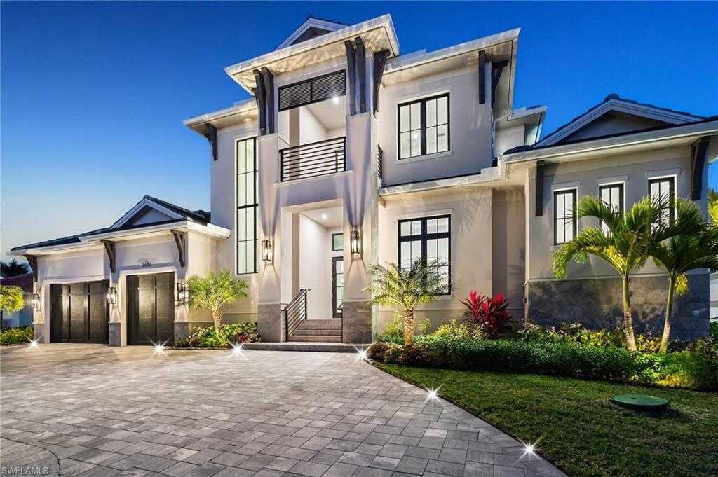 Contemporary coastal architecture with clean, modern lines is thoughtfully softened by transitional details in this stunning four-bedroom, four-and-a-half-bath Moorings residence. A striking entry through glass double doors reveals soaring ceilings, custom wood flooring, and a chic wet bar with wine storage—setting the tone for refined yet relaxed living. 

Built with quality and longevity in mind, the home features a full concrete, elevated structure, a galvanized steel tile roof, planned space for a whole-home generator, and high-end interior finishes throughout. The gourmet kitchen is a true showpiece, showcasing Sub-Zero refrigeration, Wolf cooking appliances, waterfall quartz countertops, and custom walnut cabinetry, all beautifully complemented by designer ceiling details. 

The thoughtfully designed floor plan allows for effortless entertaining, seamlessly blending indoor and outdoor living. Pocketing 8-foot sliders open to the expansive lanai with electric roll-down screens, a full summer kitchen, and a cozy outdoor fireplace—perfect for creating ambiance day or night. 

The owner’s retreat is a private sanctuary, offering a separate sitting area with direct lanai access, dual walk-in closets, and a spa-like bath. Family and guests will appreciate the upstairs living area, complete with a great room and wet bar, plus an oversized covered balcony ideal for gathering and relaxation. 

Ideally situated in the desirable north end of the Moorings, this exceptional home places you just a short golf cart ride from private Moorings beach access and the shopping and dining of Venetian Village—an ideal setting for your Naples lifestyle.