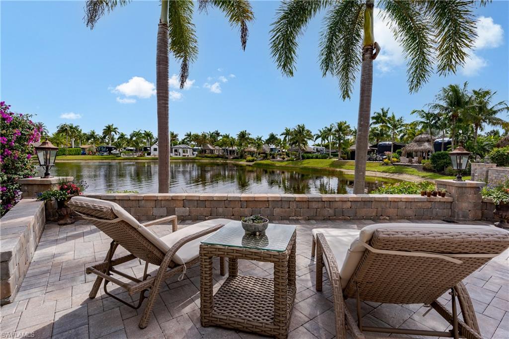 Lot 176 - Experience tropical luxury and effortless resort living at Naples Motorcoach Resort, one of Southwest Florida’s most prestigious Class A motorcoach communities in beautiful Naples. This exceptional lakefront motorcoach property offers a front-row seat to one of the resort’s most picturesque lakes, highlighted by a magnificent illuminated fountain that glows beautifully in the evening, creating a serene and unforgettable waterfront backdrop. Designed for both luxury and relaxation, the property features a spacious custom tiki hut that immediately transports you into a private tropical retreat. Rich textures, lush landscaping, and warm ambient lighting create the perfect setting for entertaining friends or enjoying peaceful sunset evenings by the water. Every detail evokes the feeling of a high-end island resort, blending elegance with the laid back charm of Southwest Florida living. The beautifully appointed casita elevates the property even further, offering a thoughtfully designed interior complete with a full kitchen, stylish living area, and private bathroom. Custom furnishings and tasteful décor make this space both functional and luxurious, perfect for hosting guests or enjoying additional comfort while at the resort. Imagine yourself relaxing on the custom sofa in a living room that rivals million dollar homes. Just beyond, an expansive screened in porch (I dare you to even see the screens they are almost invisible) allows you to fully enjoy the breathtaking lake views while staying comfortable in a bug free environment. Whether sipping morning coffee as the fountain sparkles in the sun or enjoying evening cocktails as it illuminates the water, this space becomes an extension of your living area and a favorite gathering spot.  Outdoor entertaining is effortless in this space thanks to the fully equipped outdoor kitchen, where no expense has been spared. From casual lunches to elegant evening gatherings the design of this property encourages a seamless indoor-outdoor lifestyle surrounded by tropical beauty. Ownership within Naples Motorcoach Resort includes access to world-class amenities such as three resort-style pools, spas, saunas, a clubhouse, fitness facilities, pickleball courts, dog park, and a private boat ramp providing Gulf access through the in resort waterway perfect for exploring the Ten Thousand Islands, visiting Marco Island, or boating to waterfront dining. This is more than just a motorcoach lot it is a luxurious lakefront retreat where tropical elegance, thoughtful design, and resort living come together beautifully. NIGHT TIME PICTURES COMING
CASITA FEATURES:  2026 - New Air Conditioner, 2026 - Reverse Osmosis Water Treatment System, Hunter Douglas Electric Silhouette blinds throughout Casita