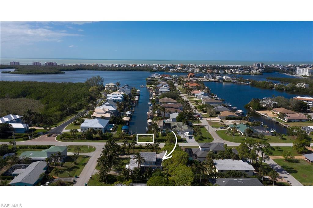 Build your coastal retreat on this oversized .40-acre double corner lot with no HOA fees, ideally located in the highly desirable Bonita Shores community — a charming hidden gem for boating enthusiasts. This exceptional offering includes a second, separately deeded waterfront parcel directly across the street with water and power for a dock, providing direct boating access and creating a rare opportunity to enjoy both beach and boating from one property. Adding to its appeal, this homesite offers enhanced privacy with no direct view into another residence. An increasingly uncommon advantage, the property is located within Collier County — setting it apart from many Bonita Shores properties that fall within Lee County. Situated across from the upscale Dolphin Cove gated community, just minutes from Barefoot Beach and within walking distance to the Bonita Shores Club, this property captures the essence of Southwest Florida’s relaxed coastal lifestyle. A build-to-suit opportunity allows you to design and create the home that perfectly fits your vision. Property is being sold as "as is" at lot value.