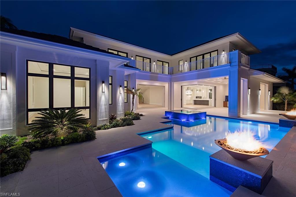 Classic Bermudian architecture infused with contemporary elegance and old Florida charm.  Penned by Falcon Design Consultants, brought to life by BBA Development, Inc., and finely appointed and furnished by Natasha Pereira Interior Design this home offers the finest in building materials and technologies to offer lasting value and peace of mind. Solid concrete construction, energy efficient materials, natural stones and woods provide not only durability, but also longevity.  Large rooms with an abundance of glass and detail, generous outdoor living spaces, both covered and uncovered, create a seamless transition from indoor to outdoor living.  Retractable screens and shutters, large pool and spa, great lift-ready 80 foot dock, and a true 4 bay garage with the ability to add lifts for the serious car enthusiast are a some of the highlights of this special offering.