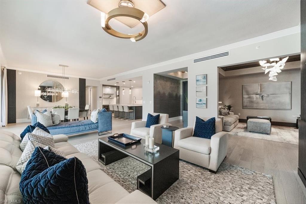 Absolutely stunning, exquisitely upgraded, elegantly furnished home at the Quattro at Naples Square!  Every detail was thoughtfully and exceptionally executed to transform this condominium into a luxurious and sophisticated oasis.  Designed with every lifestyle in mind, the Bianca has more space than any other floorplan at Naples Square with an expansive great room, a lounge area, a gourmet kitchen, and a large balcony along with 4 generous bedrooms, each with an ensuite bathroom.  Throughout the entire unit, you'll find hardwood flooring, statement making light fixtures, beautiful and functional window treatments, and unique designer flourishes, such as the custom built-ins and fireplaces in both the great room and lounge.  The kitchen is equally poised as an entertainment hub and chef's workspace with top-of-the-line equipment, by Wolf, Miele and SubZero.  Whether hosting guests or having an intimate night with family, the options for dining and relaxing in the kitchen, great room with formal dining or on the balcony are endless - with the option of creating a seamless transition with fully pocketing sliding doors.  When it's time to retreat to the bedrooms, the primary is the ultimate sanctuary featuring a luxurious spa bathroom with dual vanities, a luxurious rain shower, a Jacuzzi soaker tub, and two walk-in closets with deluxe storage systems. The adjacent guest suite is an excellent option for a home office with access to the balcony. The two larger guest suites are on the opposite side of the home to afford flexibility and privacy, and both have large walk-in closets, upgraded bathrooms, and access to either the shared balcony or a Juliet balcony. Included are two garage parking spaces, a storage unit, and access to all of the amenities of the Quattro building and Naples Square.  Perfectly located in the Naples Design District just minutes from vibrant 5th Ave S, this home's access to art, design, style, food, beaches, parks and culture is truly beyond compare.