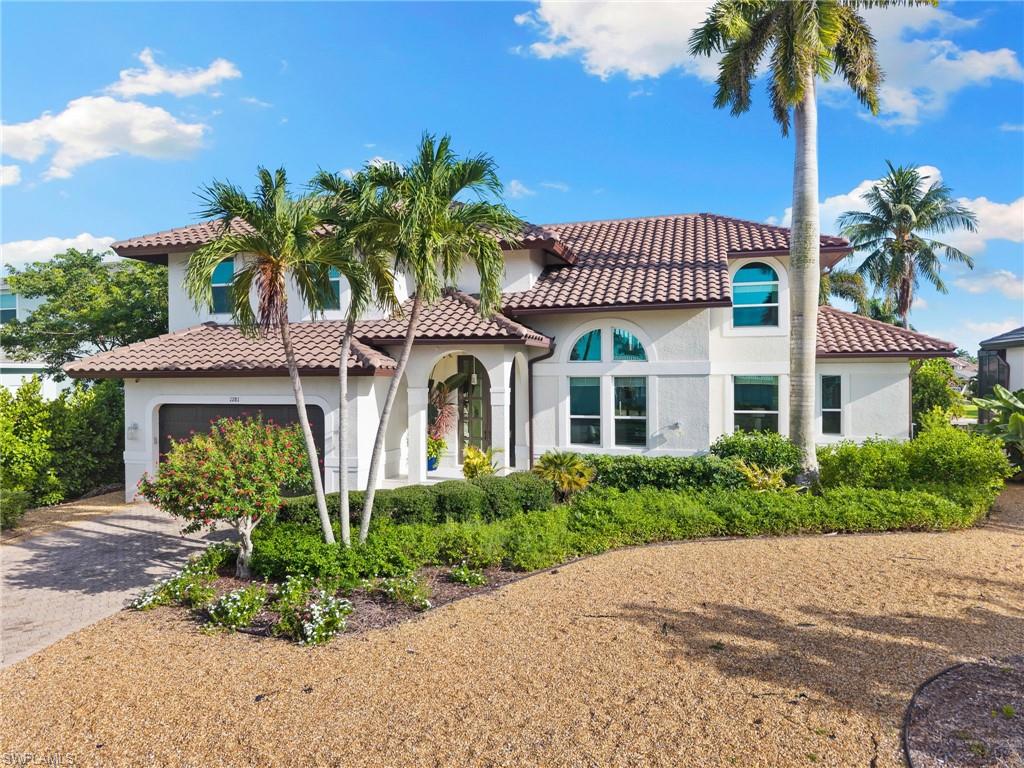 Welcome to your Marco Island boating paradise. Perfectly positioned on 80 feet of waterfront with desirable southern exposure, this exceptional residence offers direct Gulf access through the prestigious Estates and Caxambas Pass, along with wide canal and intersecting water views.
Designed for both everyday living and effortless entertaining, this spacious two-story home features four bedrooms, each with a private en-suite bath, a versatile den, two half baths, and an oversized two-car garage. Soaring ceilings, expansive windows and new impact doors and windows fill the home with natural light while providing peace of mind. The chef's kitchen is beautifully appointed with white shaker cabinetry, quartz countertops, a designer tile backsplash and premium appliances, including a double wall oven, electric cooktop, microwave, refrigerator/freezer and dishwasher. A charming breakfast nook with a bay window overlooks the water, while the formal dining area flows seamlessly into the light-filled great room with pocketing glass sliders that open to the expansive screened lanai.
The first-floor primary suite is a private waterfront retreat featuring tranquil canal views, direct lanai access, a spacious walk-in closet and a luxurious en-suite bath with dual vanities, soaking tub and walk-in shower. Upstairs, a loft with an open balcony overlooks the canal, while three generously sized guest suites each offer private en-suite baths, ensuring comfort and privacy for family and guests. Outdoor living is equally impressive. The screened lanai features a covered seating area, outdoor kitchen with sink, outdoor shower, saltwater pool and spa with a beautiful waterfall feature, all perfectly positioned to enjoy all-day sunshine thanks to the home's coveted southern rear exposure. Boaters will appreciate the private dock, 80 feet of seawall frontage and quick direct access to the Gulf of America. Ideally located just minutes from Marco Island's white-sand beaches, boutique shopping, waterfront dining and championship golf, this exceptional waterfront residence offers the very best of Southwest Florida's luxury island lifestyle.