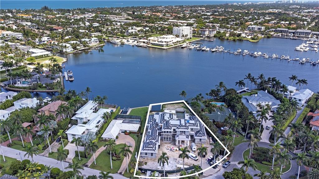 This magnificent new construction legacy property is situated on an oversized wide water parcel offering extensive bay vistas in Aqualane Shores.  This timeless West Indies styled home is a phenomenal collaboration between builder Toscana Homes, Stofft Cooney Architects, Calusa Bay, Designer Randi Scott, and Architectural Land Design.  Residence offers nearly 9,000 square feet of air conditioned living space, 5 bedrooms + den, 6 full and 2 half baths, massive pool, and 5 garages. A very rare and special offering that includes the best of everything throughout.
