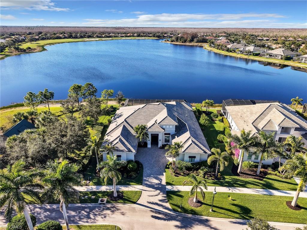 Welcome to an exceptional residence in the prestigious gated community of TwinEagles — a championship golf and country club enclave in Naples. This stunning home offers 4 bedrooms, 4.5 baths, and approximately 4,363 square feet of professionally decorated and refined living space on a beautifully landscaped 0.35-acre homesite with serene lake and golf course views.
Step inside to discover a thoughtful open floor plan featuring a generous great room, formal dining area, eat-in kitchen with nook, and a luxurious master suite with a private sitting area. The property also includes a versatile den, a 3-car garage plus a dedicated golf cart garage, and elegant interior finishes throughout.
Outdoor living in this home is truly extraordinary — enjoy an oversized screened lanai with custom pool and spa, a gas fireplace, and a fully equipped summer kitchen — all perfectly positioned to take in breathtaking views across the water and fairway.
Located just minutes from world-class beaches, fine dining, shopping, and cultural attractions, this turnkey furnished residence embodies the best of Southwest Florida living with resort-style amenities, including golf, tennis, fitness, dining, and social events at TwinEagles.
