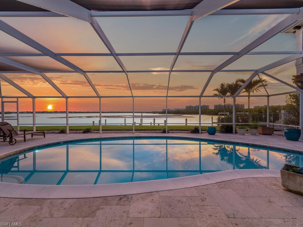 A bayfront legacy property located in The Olde Marco Historic District is now available for purchase. Here's your chance to own a Florida ranch style house with 3 bedrooms, 3 full baths, spacious living area with built-in cabinets and desk area, galley style kitchen and dining space overlooking sparkling water views. Outside offers a large travertine covered deck space with electric hurricane shutters and expansive screened pool deck. Epoxy floor garage with laundry and workshop area. Western exposure overlooking Collier Bay this 80x150 property is a rare opportunity to capture the essence of waterfront living along the Marco River with direct access to the river on one of the most desirable locations on Marco Island, just a half mile distance to 6 local restaurants and attractions. Discover the ultimate island lifestyle with stunning panoramic views of emerald waters and cruise by boat to nearby Coconut and Keewaydin Islands. Immerse yourself in the tranquility of this serene paradise with an abundance of bird watching, mangroves, wildlife, dolphins, manatees, and yachts cruise past this once in a lifetime location. With expert design, the possibilities for a new construction estate on this parcel are endless. Marco Island offers world-class resort style shopping, fine dining and iconic white sand beaches. Being sold AS-IS.