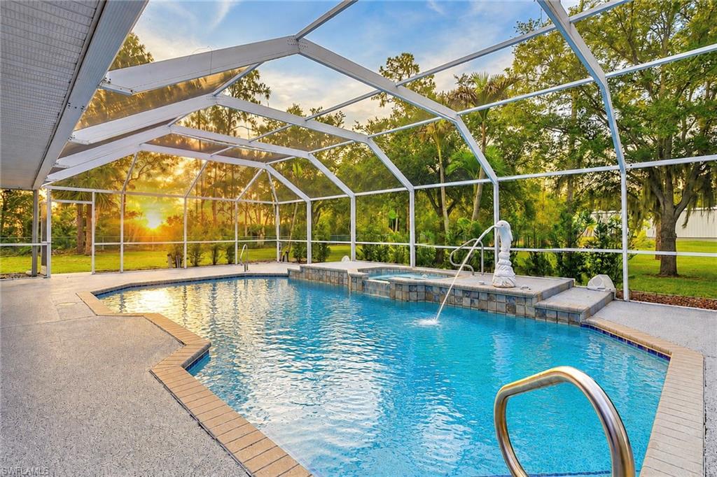 AMAZING OPPORTUNITY to own one of the most unique estate properties in Southwest Florida. Situated on 2.41 private acres in the highly sought-after Briarcliff acreage community, this custom-built 5-bedroom, 4-bath pool home offers the perfect blend of luxury living, functionality, and space for all your hobbies, toys, equipment, or business needs. The true centerpiece of the property is the impressive 5,000-square-foot enclosed Red Steel detached garage featuring approximately 1,800 square feet of air-conditioned space, a workshop, upstairs billiards room and bar, two 14-foot and one 10-foot automatic garage doors, 50-amp and 30-amp electrical hookups, a separate 150-amp electrical panel and meter, and approximately 24 feet of entry clearance. Whether you're a car collector, RV enthusiast, business owner, contractor, or simply need extraordinary storage space, this facility is designed to accommodate everything from boats and motorhomes to commercial vehicles and equipment. A circular driveway welcomes you to the main residence, while an additional 1,300 feet of paved driveway leads to the rear of the property, providing ample parking and enough room to comfortably maneuver large trucks and trailers. Inside, the home features a desirable split-bedroom floor plan with laminate and tile flooring throughout, soaring 12-foot ceilings in the secondary living area, and a centrally located wood-burning fireplace that creates a warm gathering space. The spacious kitchen is designed for both everyday living and entertaining, featuring granite countertops, custom maple cabinetry, stainless steel appliances, a temperature-controlled wine refrigerator, ceramic tile flooring, and a convenient butler's kitchen. Additional interior features include an oversized Maytag washer and dryer, a four-speaker surround sound system, dual air conditioning systems, hurricane-rated electric shutters, and an ADT monitored security system with fire and lightning protection.Step outside to your private outdoor retreat featuring an 18-by-23-foot screened pool enclosure surrounding a heated saltwater pool and six-jet spa. The pool equipment has been recently serviced, including the heater, pump, and control systems. The property also features a spring-fed pond and AG-2 zoning, offering flexibility and opportunities rarely found in today's market. This exceptional estate is located in South Fort Myers and offers a lifestyle that simply cannot be replicated. Whether you're seeking a private family compound, home-based business headquarters, collector's paradise, or luxury acreage retreat, this property delivers a truly rare combination of space, privacy, and versatility. (one or more photos have been digitally edited by adding images of furniture)