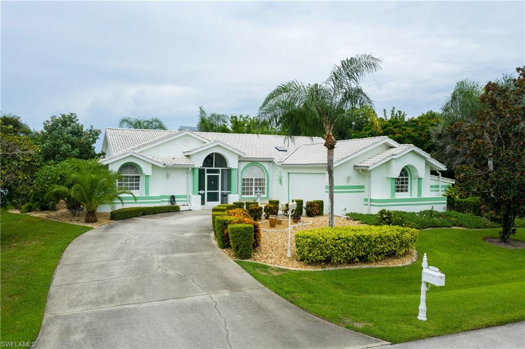 CUSTOM BUILT 3/3/2 ON HUGE DOUBLE LOT WITH 186’ ON THE LAKE IN DEED RESTRICTED BURNT STORE LAKES! EASY ACCESS COMMUTING NORTH OR SOUTH! Beautiful landscaping on both sides of home for ultimate privacy. Inviting open floor plan features high ceilings, large living room with wood burning fireplace as beautiful focal point, double sliders to lanai, formal dining room and updated kitchen with solid wood cabinets, granite, tile backsplash, built-in oven and microwave, cooktop, breakfast bar and dining nook overlooking water views. Master suite offers slider to lanai and private bath with dual sinks, jetted tub, walk-in shower and walk-in closet. Third bedroom is oversized to make a great office or den/family room. Outdoor entertaining area features covered and screened lanai with room for pool and already has outside bath with walk-in shower. New a/c in 2019, water heater replaced in 2015 and hurricane protection. Burnt Store Lakes features 11 fresh water lakes for fishing and is close to boating, golf, parks, restaurants, shopping, schools and gulf beaches. Canoe/kayak ramp to Charlotte Harbor and only minutes from Burnt Store Marina offering extensive resort and golfing facilities.