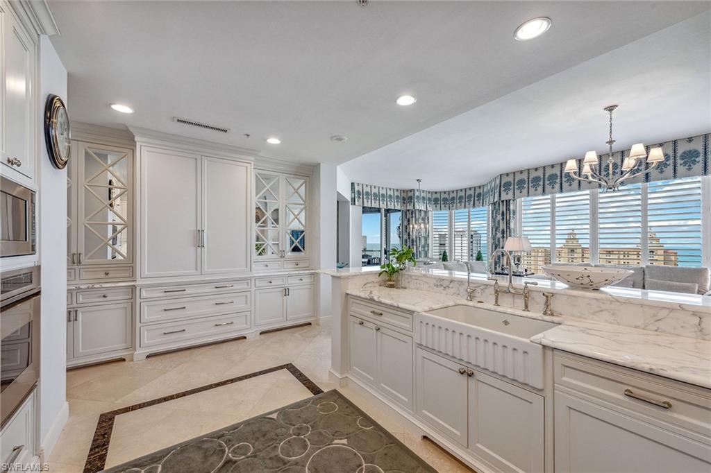 Fantastic high-floor views and soaring ten-foot ceilings greet you as you enter this professionally designed residence from your elegant private elevator foyer with over 4,100 square feet encompassing four bedrooms with a family room and four-and-a-half baths. The inviting great room features abundant space for casual living, dining, and outdoor entertaining options. The spectacular chef's kitchen features Carrara marble countertops, Sub-Zero refrigeration with two slide-out freezer drawers, a Wolf cooktop, finely crafted Shackleton cabinetry, designer lighting, and Baldwin door hardware throughout. Custom window treatments and wall coverings accentuate the designer appeal and attention to detail. Parking includes a private one-car garage and two additional under-building parking spaces. Trieste residents enjoy a resort-style pool with a private entertainment cabana, an updated social room, a fitness center, a lobby, a theater, and onsite guest suites. Bay Colony residents enjoy the private Beach Club with a restaurant, pool, bar, and fully attended beach services as well as tennis at the Bay Colony Tennis Club.