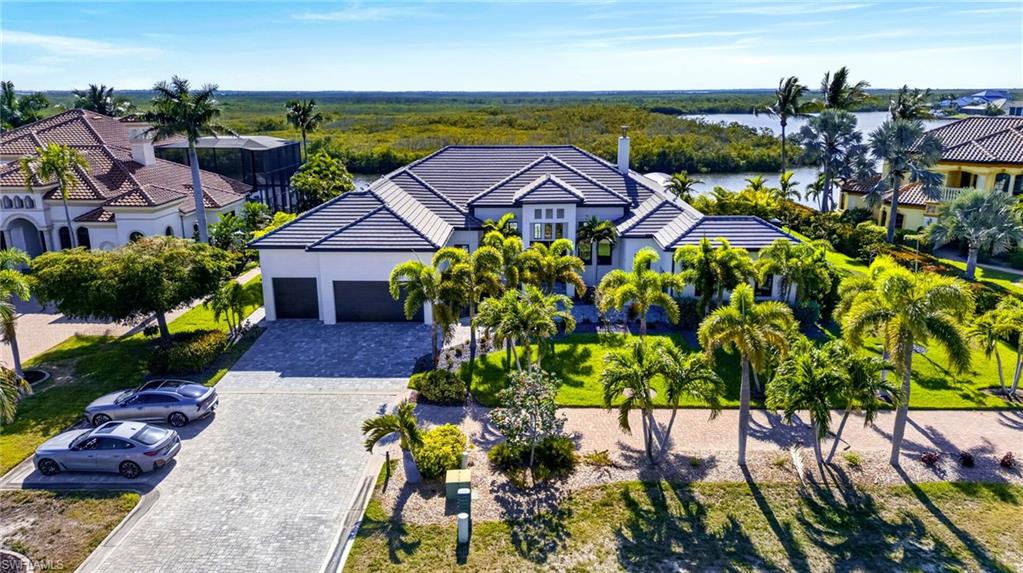 Experience the pinnacle of ultra-luxury living in this European-inspired modern and contemporary estate located in the prestigious community of West Cape Estates. Situated on the north spreader canal with western exposure, this property offers stunning sunset views of the preserve and intersecting canals.

The estate is a boater’s dream, featuring 140' of Titan composite decking, a 20,000 lb Golden boat lift, and a 35' boat slip (modifiable for a 40' boat) with direct access to open water in just 34 minutes with zero bridges!! Additional amenities include a 7,500 lb Golden lift with lowered dock for kayaks, a 120 SF Tiki Hut with full utilities including WIFI, and even a snook light for night fishing!

The interior boasts impeccable European design, including an elegant wood-burning fireplace that anchors the living area while the chef's kitchen dazzles with high-end appliances from Dacor, Bosch, Thermidor and Miele and a European inspired kitchen layout complete with a 21' floating island with custom cabinetry from Milino that has all the functionality of European design standards.

- Entertainment: Sound optimized Movie Theater with seating for 5 with Italian leather movie theatre style recliners, 13 Bowers & Wilkins speakers and subwoofers with a high performance Marantz processor, Sony 4K HD laser projector, and a 22TB Kaleidescape movie server.  Movies can be streamed, played from a high end BlueRay player or the Kaleidascape.
- Smart Home Features: Full integration of Smart Home System for security, sound, lighting, and electronic shades, all controllable via phone or dedicated panels.  
- Living Space: 12' ceilings with customized acoustic drop down ceiling panels for optimal sound absorption and 10' zero-corner sliders.   Audio sound system throughout the entire home and lanai area with James brand speakers.  Security system with motion sensors throughout.  High level quartz countertops throughout, Italian Madeli lighted mirrors with defoggers in all bathrooms, LED lighting with Lutron switchs and custom Milino European inspired floating cabinetry throughout bathrooms and bedrooms.  Every detail in this home has been curated to evoke sophistication, from the modern architecture style to the sleek, custom finishes!  The home is being sold fully furnished with high-quality furnishings from Scan Design. 

The outdoor oasis includes a 720 SF saltwater pool with negative edge, a "swim-in-place" feature, an 8-person heated spa, 4 fire burners, and a large outdoor kitchen area with fire pit and seating area and a spacious sundeck area.  Electric and gas heat available for the pool and spa.  The ODK is equipped with upgraded 24" gas grill with side burner and addtl Teppanyaki 19" griddle and refrigerator.  You can also enjoy the peaceful and serene setting in the Pergola and garden area with seating for 6!!

There are too many upgrades to list!!!  Schedule your private showing today to see this breathtaking home!!