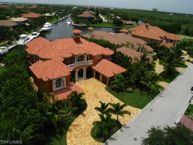 This turnkey magnificent 6683 sq. ft. furnished estate sets a new standard for quality, elegance and unsurpassed luxury. Located in SW Florida's Premiere Waterfront Community this home offers an overly spacious floor plan maximizing indoor/outdoor living spaces. In addition to 5 large BR suites, there is a formal library w/custom wood finishes, state of the art media room & billiards room, gourmet kitchen, & detached guest suite. You will be awestruck by the resort-styled outdoor screened lanai & pool area w/bamboo ceiling, summer kitchen. The floating dock accommodates a large yacht right in your own backyard.