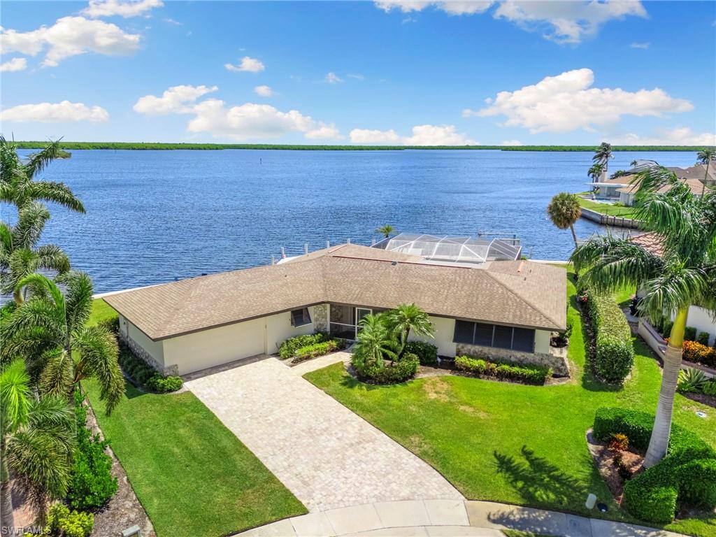 NEW 170 FT. SEAWALL (2023), NEW SEAWALL CAP (2023). Breathtaking waterfront property ready to build your dream home or enjoy this move-in ready island home to take in stunning wide open water views of East Marco Bay and Sanctuary Sound. This Deep Water Direct Access property features an impressive 170 feet of water frontage with new jet ski lift (2024) and new boat dock (2023). This property offers safe protected harbor for your boat or yacht. This is a must see property and incredible investment opportunity to take advantage of one of the best views on Marco Island. This split floor plan home features 3 Bedrooms 2 Baths that have been beautifully updated, offering gorgeous water views from every room in the house. Updates include newer roof, new kitchen cabinetry, quartz countertops, luxury tile flooring, new refrigerator/freezer, new dishwasher, new range, new washer/dryer (2023), new microwave (2024), new pool heater, new salt water pool system (2023), new exterior painting (2024), and new hot water heater. The home also offers storm shutters and a spacious screened-in lanai pool area. This property features beautiful sunrises in the morning, while still enjoying all day sunshine in your pool by having both east and southeast rear exposure. See dolphins play and take advantage of the excellent fishing grounds from your backyard. Watch the sunset reflect over the water and the moon at night. Make this your new home in paradise on Marco Island.