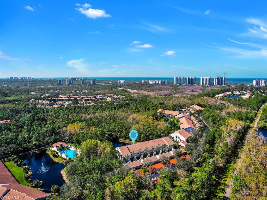 PERFECT NORTH NAPLES LOCATION WEST OF 41 offers tranquility and peace in a tropical oasis of 90 units in 31 forested acres within a gated community!  Enjoy the stunning canopy of trees, beautiful flora bathed in natural light and a sparkling lighted waterfall/preserve view. Second floor unit with an oversized screened lanai, a summer kitchen with built-in electric grill, refrigerator and sink. This “Cascades” offers an open floor plan with inside laundry room and sink, an oversized 1 car garage and a driveway that can accommodate extra cars. The primary suite bathroom has double sinks, soaking tub, large shower, a large closet and pair of French doors to the lanai. The light and bright living and dining areas have tile flooring, 12’ vaulted  ceilings and face the beautiful private southern water panorama and sunset views. See the spacious white kitchen with breakfast bar and a bright eat-in area. Try the large community pool or the popular Delnor Wiggins Beach State Park, Barefoot Beach Park and Vanderbilt Beach with sugar sand beaches! Close to shopping, dining, entertainment and sports experiences in one of Naples most desirable locations. A true hidden gem waiting for you!