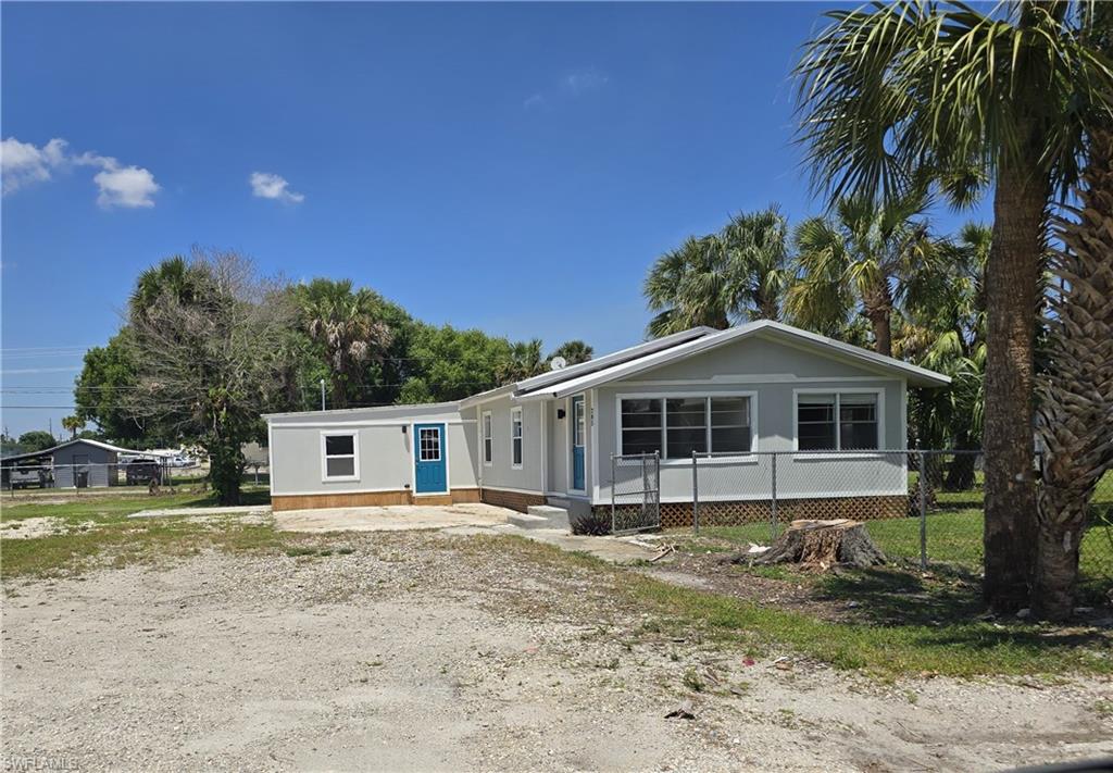Welcome to this beautifully remodeled 4 bedroom, 2 bath home situated on over half an acre (4 lots) within the city limits - offering over 2,300 sq ft of space, flexibility, and convenience all in one!  This move-in ready home has been thoughtfully updated with new flooring throughout, a durable metal roof, and a new a/c system with warranty, giving buyer's peace of mind for years to come.  Step outside and enjoy the charm of a spacious corner lot with a fully fenced yard, perfect for pets, entertaining, or simply enjoying your own private retreat.  Mature shade trees provide a serene setting, while the new sun deck off the back door creates the ideal spot for morning coffee or evening relaxation.  Need extra storage?  You'll appreciate the on-site storage shed for tools, toys, or hobbies.  With it's generous land size, modern upgrades, and prime in-town location, this property offers the perfect blend of comfort, space, and convenience.