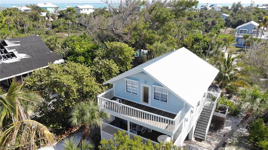 Island Living with Room to Expand – A Rare North Captiva Opportunity

Welcome to 201 White Pelican Way, a unique island retreat located on North Captiva, a private boat-access-only barrier island just off the coast of Southwest Florida. Known for its pristine beaches, turquoise Gulf waters, abundant wildlife, and peaceful golf-cart-only lifestyle, North Captiva offers a level of tranquility that’s becoming harder to find.

This elevated island home features a 1-bedroom, 2-bath main residence plus a den with potential to convert into a second bedroom, offering flexible space for guests or additional sleeping quarters. The property also includes a separate ground-level 1-bedroom, 1-bath apartment, ideal for visitors, extended family, or generating rental income.

Designed to embrace the outdoors, the home features multiple levels of decking and sitting areas, creating inviting spaces to relax, entertain, and take in partial Gulf views and coastal breezes. Whether enjoying your morning coffee at sunrise or watching the stars come alive at night, the outdoor living spaces capture the true essence of island life.

The property also includes several storage buildings, perfect for golf carts, beach gear, fishing equipment, and island essentials.

Adding even more value, the sale includes the adjoining lot behind the home, opening the door to exciting possibilities. Create a large private pool and outdoor living oasis, expand the existing property, or build a second home for guests or additional rental potential.

North Captiva is a destination where dolphins play offshore, pelicans glide overhead, and the night sky is filled with stars. Accessible only by boat or ferry and navigated by golf cart, the island offers a laid-back lifestyle surrounded by beautiful beaches, incredible fishing, and protected natural preserves.

Whether you're looking for a private island getaway, a full-time retreat, or an investment property with strong vacation rental appeal, this property offers a rare opportunity to own a true piece of North Captiva paradise.