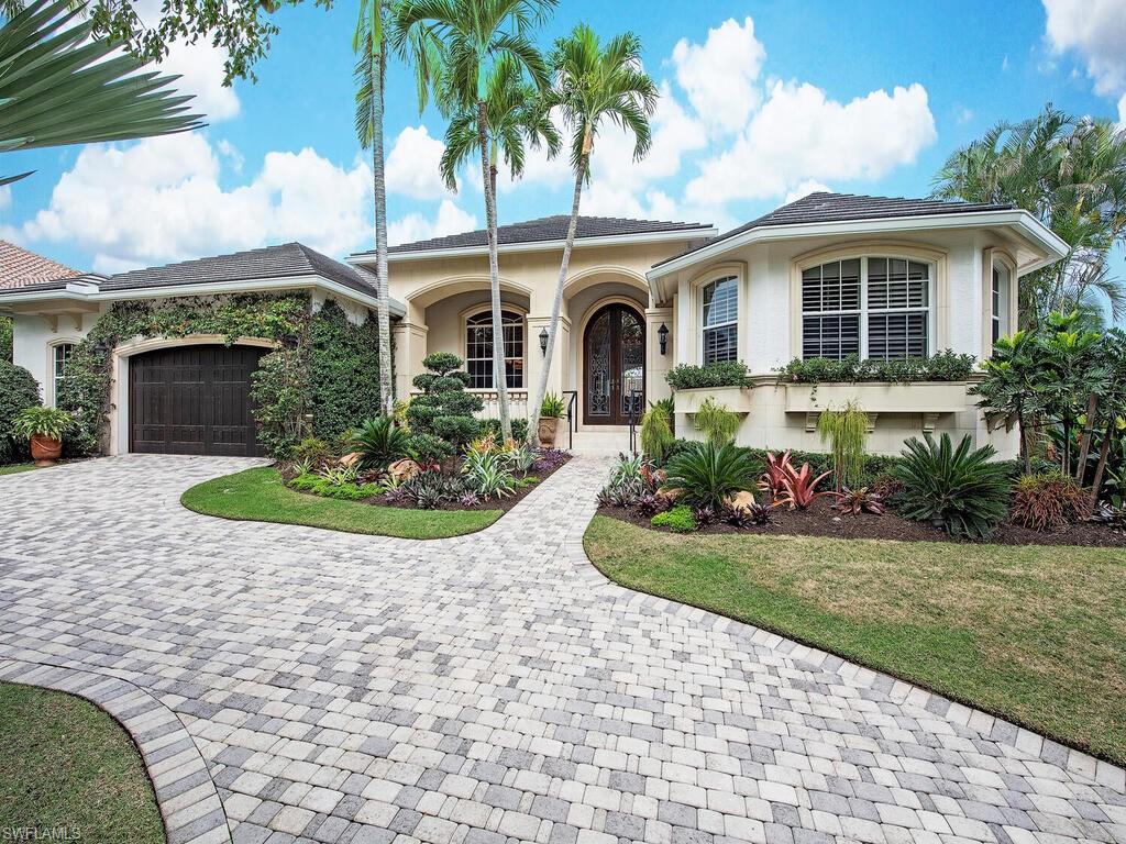 H4495 - Enveloped in lush environs, this remarkably elegant and spacious residence bestows every ounce of style and comfort one could desire, all the while being located within seconds to all that Downtown Naples has to offer.