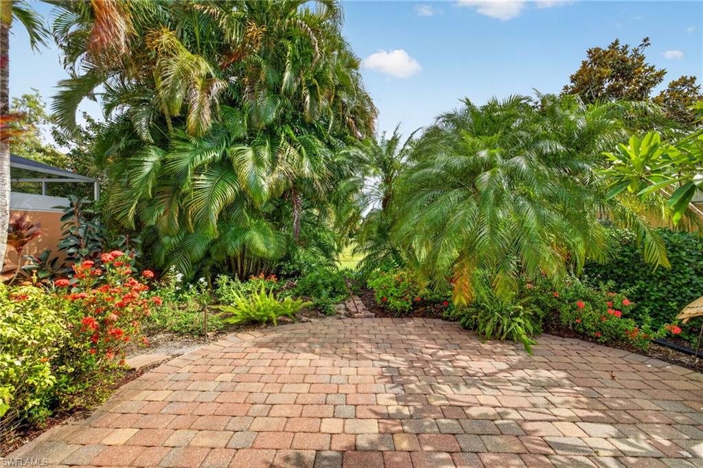 Welcome to this beautifully maintained Capri floor plan villa in Bonita Springs, Florida, located within San Remo, a charming and neighborly community of just 342 residences built by renowned Divosta Homes and known for their solid poured concrete construction.

This spacious residence offers two bedrooms, two baths, a two-car garage, and an extended den/sunroom enhanced by high ceilings and abundant natural light. Freshly painted inside and out in 2026, the home features a full suite of kitchen appliances replaced in 2026, updated kitchen and primary bath fixtures, accordion-style storm shutters, impact sliding doors, and a desirable split-bedroom floor plan.

Thoughtful upgrades throughout reflect pride of ownership, including pull-out kitchen shelving, dual waste and recycling storage, generator wiring already in place for six areas of the home, a quiet garage door system with updated keypad access, and a premium garage door sweep and seal.

The true showpiece is the extraordinary outdoor living space. A gorgeous brick paver patio overlooks the lake while remaining remarkably private thanks to a colorful pollinator garden that creates a tranquil retreat. The secluded terrace offers a rare combination of waterfront living and privacy seldom found in attached villa communities.

Located outside of flood hazard areas, this home benefits from favorable community fees compared to many Bonita Springs neighborhoods while providing the storm-ready features and quality construction for which Divosta homes are known.

San Remo's prime Bonita Springs location places residents just minutes from the future Midtown Bonita development, approximately 20 minutes from Southwest Florida International Airport (RSW), and within easy reach of the white sugar-sand beaches of Bonita Beach.

Whether you're seeking a seasonal escape or a full-time Florida residence, this move-in-ready villa delivers privacy, comfort, quality construction, meaningful updates, and an exceptional Bonita Springs lifestyle.