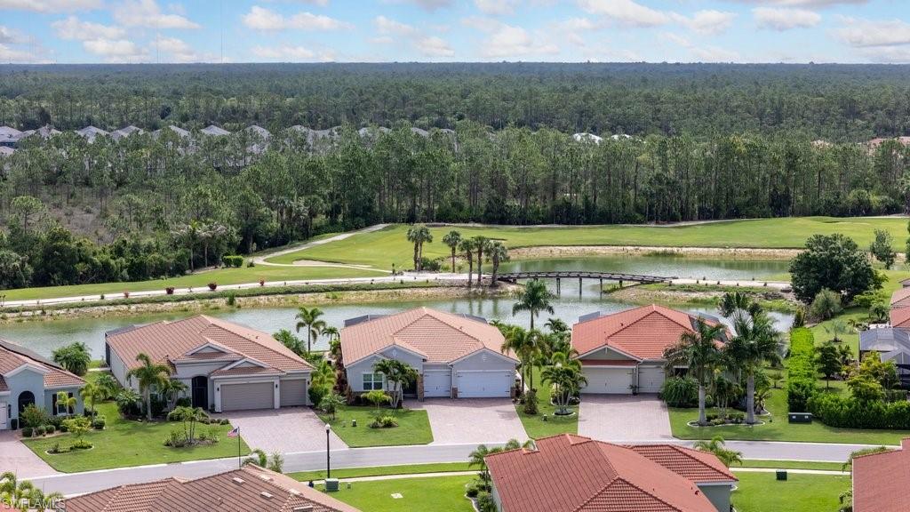 A PREMIER GOLF AND WATERFRONT HOMESITE WITH A VIEW THAT STEALS THE SHOW! Perfectly positioned to capture breathtaking views of the 3RD GREEN, 4TH TEE BOX, SPARKLING LAKE, AND CHARMING WOODEN BRIDGE, this exceptional property offers one of the most scenic settings in Magnolia Landing. The unique combination of golf, water, and bridge views creates a picturesque backdrop that can be enjoyed from both inside the home and the expansive 27'8" x 12'4" COVERED LANAI, providing the perfect setting for entertaining, outdoor dining, or relaxing while enjoying the ever-changing scenery. The highly sought-after ABBEY FLOOR PLAN offers 3 BEDROOMS + DEN, 2.5 BATHS, AND A 3-CAR GARAGE, thoughtfully designed for comfortable everyday living and effortless entertaining. The spacious primary suite features an upgraded tiled walk-in shower, dual-sink vanity, private water closet, and TWO CUSTOMIZED WALK-IN CLOSETS, while the guest bedrooms are connected by a convenient Jack-and-Jill bath. Additional upgrades include a BUILT-IN OUTDOOR KITCHEN WITH SEPARATE GRILL, outdoor multi-spray shower, Epoxy-Finished Garage Floor, **Crown Molding** in the main living areas and primary bedroom, stylish kitchen backsplash, and a COVETED PREMIUM LOT. Located on desirable AVENIDA DEL VERA, known for its longer driveways, enhanced curb appeal, and premium homesites, this residence combines exceptional outdoor living with one of the community's most captivating golf and waterfront views. Residents enjoy Magnolia Landing's outstanding resort-style amenities including TWO COMMUNITY POOLS, FITNESS CENTER, PICKLEBALL, BOCCE, SHUFFLEBOARD, ON-SITE DINING, AND OPTIONAL GOLF MEMBERSHIPS OR PAY-AS-YOU-PLAY GOLF, creating the Florida lifestyle that has made Magnolia Landing one of Southwest Florida's most popular gated golf communities.