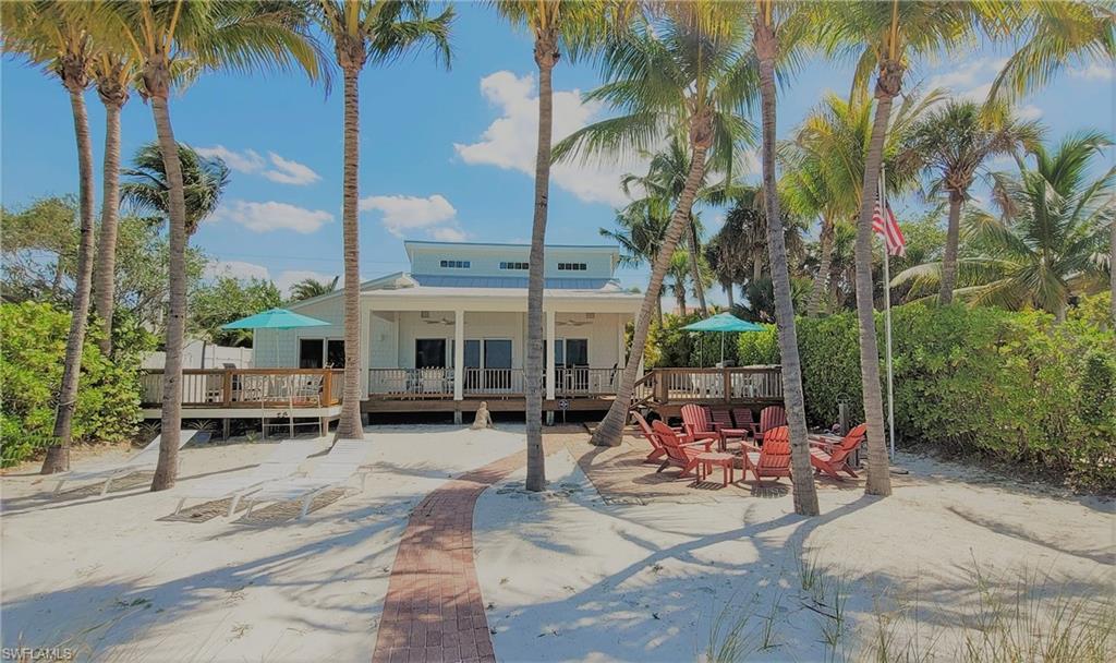 Ultimate Classic Florida gulf front home with separate guest cottage. This gorgeous beach home has 3 bedrooms, 3 bathrooms, soaring ceilings in the main areas and an open loft upstairs currently used as an art studio. Lots of history throughout this charming property built in 1948, originally known as Aloha 1 and Aloha 2. Original Florida pine wood floors, large open decks overlooking the beautiful gulf waters and sandy beach. Relax in your private hot-tub as you watch dolphins frolic in the gulf and the gorgeous sunsets, which can also be viewed from many rooms of the main home. Enjoy outdoor entertainment with family and friends in your beach yard, shelling, swimming in the gulf, or out on the spacious decks. The adorable guest cottage has its own entrance and open deck and a workshop underneath, as well as extra storage for outdoor toys. This spacious gated residence has a paver brick entrance and driveway, covered carport with lots of storage and plenty of room for more entertaining! There are too many unique features about this property to list. This is the place where family and friends gather to make cherished memories. This gulf front classic on Fort Myers Beach won't last.