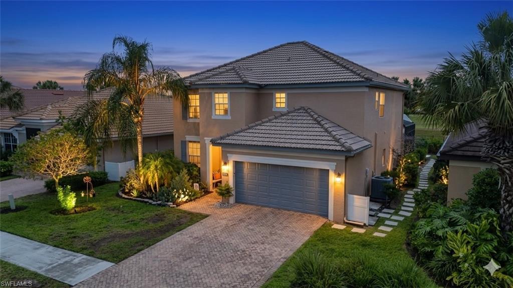 Enjoy nearly 2,600 sq. ft. of comfortable living space in this 4-bedroom plus den, 2.5-bath residence. Positioned on a lakefront lot, this home offers a functional great room floor plan featuring 9ft ceilings and tile/wood-look flooring throughout—no carpet! The kitchen is designed for easy gatherings with a breakfast bar, nook, and adjacent formal dining area. The second floor hosts oversized bedrooms, including a generous primary suite with dual walk-in closets and a bathroom featuring dual sinks, a soaking tub, and a separate shower. Significant mechanical peace of mind is provided by a BRAND NEW AC unit. Outdoor living is a breeze on the full-length screened lanai, featuring a heated saltwater pool and spa. While privacy plantings currently frame the backyard, the property boasts a direct lakefront position. Additional features include a 2-car garage with epoxy flooring, tile roof, storm shutters, and wiring for outdoor lighting. Orange Blossom Ranch residents enjoy a premier amenity package: 2 resort pools, 2 spas, fitness center, tennis, basketball, splash pad, and a social clubhouse. A large-scale floor plan in a prime Naples location with major updates already handled.