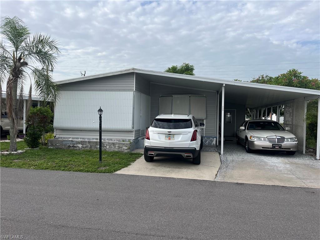 TALK ABOUT GORGEOUS.  WOW.  You have got to come see this NEWLY REMODELED unit in Tamiami Village. This is basically a brand new home!!!!  NEW TILE FLOORS THROUGHOUT!!!  New Kitchen Cabinets, Granite Island which seats 4.  Stainless Steel Refrigerator with Icemaker, tons of storage, tile in cabinet floors!!!! Separate Bar Area, Newly remodeled bathroom counters, Cabinets & Showers GORGEOUS.  DRYWALL CEILINGS & WALLS THROUGHOUT. Studs were switched out to heavy duty 2x4. HUGE Driveway.  Come & enjoy this beautiful home.  Did I mention the 2 HUGE mango trees for your enjoyment?  Private back yard.  Mostly furnished, just need to add some living room furniture.  Enjoy 3 pools, tons of activities, close to shopping, dining, golf, beaches.  This is the ONE!!!