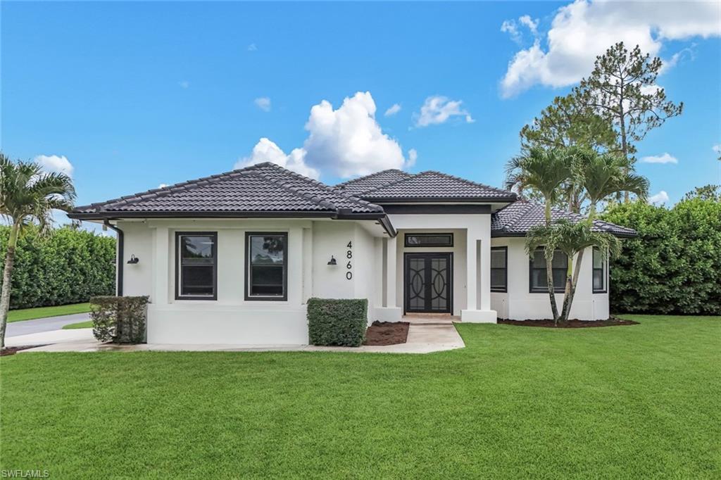 Discover the perfect blend of privacy, functionality, and Florida outdoor living with this beautifully maintained 3-bedroom, 2-bath home situated on 2.27 acres of 100% upland property in the highly sought-after Golden Gate Estates. Fully fenced and secured with an automatic metal entry gate, this move-in-ready residence offers the space, freedom, and versatility that are increasingly difficult to find while being just minutes from everyday shopping, dining, and the newly developed Shoppes at Orange Blossom plaza. Designed for comfortable everyday living and effortless entertaining, the home features a thoughtfully laid-out floor plan with custom cabinetry, quality finishes, and surround sound speakers throughout. The spacious kitchen and living areas create a welcoming atmosphere for family and guests, while the whole-house reverse osmosis system provides exceptional water quality throughout the home. Step outside and enjoy one of the property's standout features—a fully equipped outdoor kitchen with granite countertops, perfect for hosting family gatherings, weekend barbecues, and taking full advantage of Southwest Florida's year-round outdoor lifestyle. The expansive backyard provides endless opportunities for recreation, gardening, pets, or future additions. Security cameras positioned around the property offer added peace of mind and convenience.
The fully fenced 2.27-acre parcel offers ample room for vehicles, equipment, boats, RVs, trailers, and recreational toys, making it ideal for those seeking both space and flexibility. Adding even more value is the large detached shop/building located at the rear of the property. Whether used as a workshop, hobby space, storage facility, or for business purposes, this versatile structure provides countless possibilities to meet your needs. With 100% upland acreage, privacy, security features, premium outdoor amenities, and a highly functional layout, this property presents a rare opportunity to enjoy the best of Golden Gate Estates living. If you're looking for a move-in-ready home with room to grow, space to entertain, and the freedom that comes with owning a large, usable parcel of land, this exceptional property is a must-see.