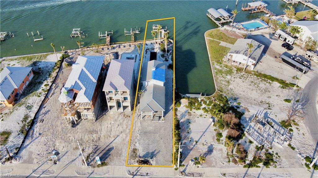 The Edge of the Water!  Rejuvenate this north end, Ft Myers Beach bayfront-beauty.  Structural Inspection completed on this multi-level single family home.  Breathtaking panoramic water views of the Estero Bay, no bridges out to the gulf, where environmental stewardship never goes out of style.   A short walk away from the soft white sands of the beach.   457 Estero Blvd offers over 200ft of wrap around seawall and just under on-third of an acre, paved driveway with ample parking areas. Rare opportunity to own one of the best bayfront locations where open-air spaces form an essential element of this 4-bedroom home. Destination found with this waterside serenity combined to invigorate a perfect balance between boating lifestyle and relaxation.  It emits a feeling that is simultaneously unassuming and ability to style to your own transformation adding finishing touches.  Seawall repair in place and under construction.   This is your year, your place in the sun and on the water.