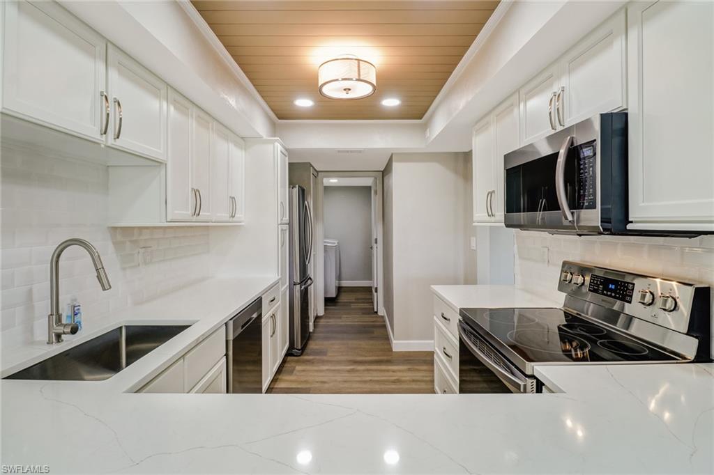 CASH ONLY - Unless the buyer is willing to waive the appraisal contingency. Incredible views await you- this Immaculate 1st floor condo was just completely remodeled & overlooks Lakes Regional Park- 279 acres of freshwater lakes & preserve with walking, jogging & biking paths. New 2.5 Ton Trane A/C, NEW stainless Samsung appliances, white shaker Cabinets w/dovetail & soft close drawers, faucets, electrical outlets, waterproof vinyl Flooring, baseboards & trim, even new doors!  Beautiful Lincoln Quartz counter tops in the kitchen & bathrooms compliment the flooring & new tiled shower surrounds. Collapsible/pocket sliders out the back let you open the living into your tiled screened porch. Electric hurricane shutters provide extra security + protection for your home. Recessed lighting gives you bright light while working from home or cooking in your new kitchen. Large Master bedroom has a water view too. There's custom built-ins in all closets. Enjoy a cocktail from your custom built-in bar while watching the sunset on your back porch. There's a large heated community pool, fitness room, tennis & pickleball courts, clubhouse with media room.