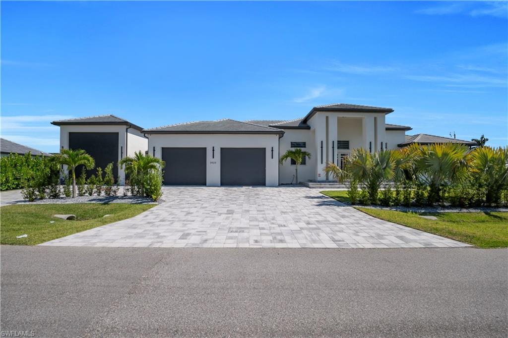 The seller asks for serious buyers only. Any buyer coming to a showing must come (by appointment only) with their own agent.

Be the proud owner of quite possibly the crown jewel of the neighborhood! This house was built in 2024, and sits on an oversized corner lot, slightly larger than a triple lot, 135x125, or about 0.38 acres.

This house has 3,523 sq ft of living area, with a total of 4,918 sq ft. It has a paver driveway, and it has an oversized garage, plus an RV garage big enough to park a rig up to 43’, with an extra washer, dryer, and sink. Both garages have a fresh coat of epoxy on the floor, as well as a breezeway between them. It is set up with city water & sewer. There is foam insulation throughout the whole house, in the walls and ceiling. The house is surrounded by many trees and hedges for an elevated sense of privacy. The house consists of four bedrooms + flex room, which can be used as an office, another bedroom, etc, and SIX bathrooms. Every room comes with zebra curtains. The kitchen comes with modern appliances and quartz countertops and shelves. The living room feels almost cavernous with its 15 foot high coffered ceiling with a custom vaulted design, and a fireplace surrounded by illuminated built-in cabinets. It has a tile roof, impact windows & impact doors, and plenty of storage space. It houses a 500 gallon propane tank outside, plus an entire outdoor kitchen with grill, oven, cooktop, and kitchen sink, and two powerful ceiling fans recently installed. The floors are all porcelain tile, so they are low maintenance. This house gives an air of elegance inside and out. The bedrooms are very spacious, with bathrooms to match.

It has a saltwater pool and spa, with a heater, and a screen enclosure with a spacious paver deck for you to roam in, which is surrounded by a tower-like wall, giving you the kind of privacy you likely won’t find anywhere else!