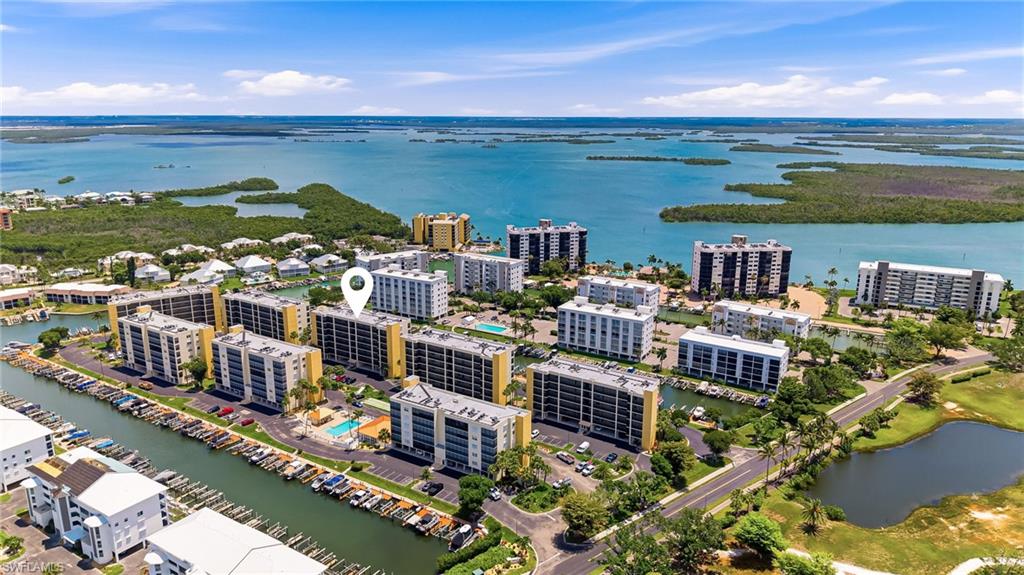Welcome to Hibiscus Pointe, one of Bay Beach’s most desirable condominium communities, where island living is paired with comfort, beauty, and everyday convenience. This beautifully maintained 2-bedroom, 2-bath condo offers under-building parking, peaceful canal views, and lovely morning light over Estero Bay. Offered turnkey, it provides an effortless way to begin enjoying the beach lifestyle, with private EBIA parking near the beach access and the Gulf’s white sand just moments away. The residence features a comfortable, well-planned layout along with thoughtful updates, including a newer A/C, a new water heater in 2025, and a full re-piping completed in 2026. The railings and screens have also been replaced with 20/20 no-see-um protection, creating a comfortable outdoor lanai for morning coffee, evening breezes, and quiet moments overlooking the water. The back lanai is also equipped with hurricane shutters for added peace of mind. Hibiscus Pointe has seen impressive improvements in recent years, with beautifully maintained grounds, a refreshed amenity center, and an inviting community pool. Residents also enjoy access to a wide variety of EBIA amenities, including pickleball, tennis, bocce, putting greens, a driving range, and scenic walking paths around the ponds. A refined island retreat with comfort, convenience, and timeless appeal.