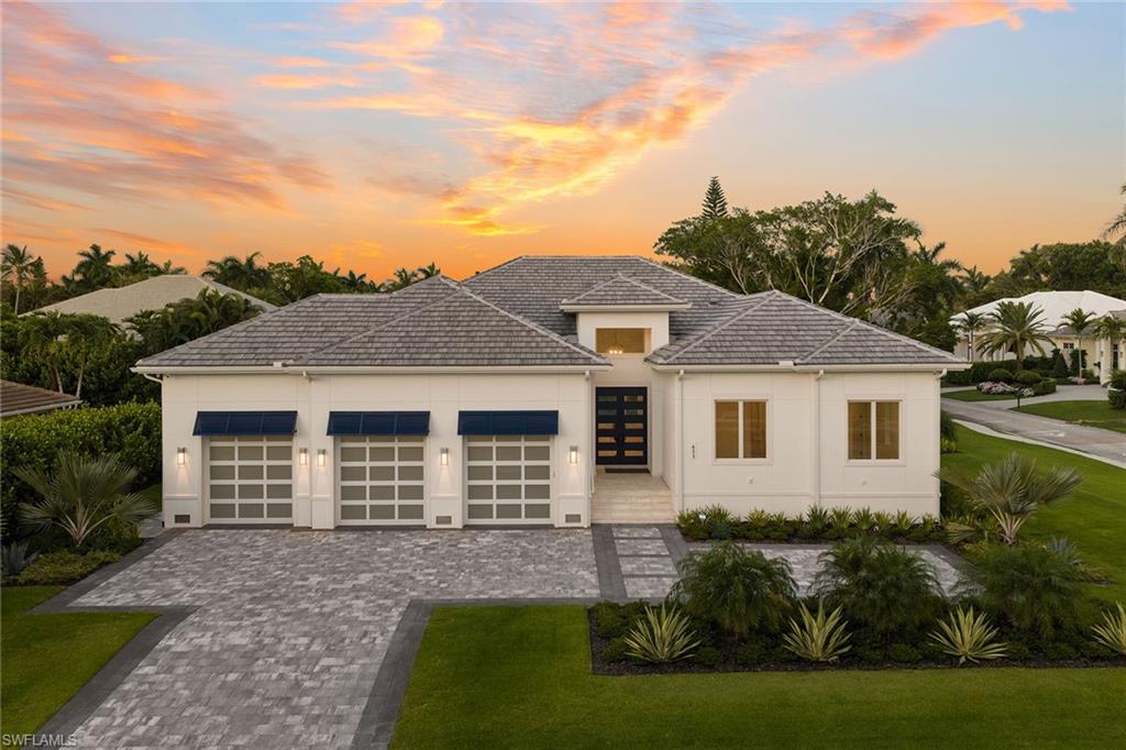 Perfectly positioned in one of Naples’ most desirable coastal neighborhoods, 623 Park Shore Drive offers the rare combination of luxury new construction, an active lifestyle and private beach access. Located just moments from The Village Shops on Venetian Bay and the Park Shore Private Beach Park, this residence places world-class dining, boutique shopping, sunsets and the Gulf of Mexico within easy reach. This newly constructed concrete block residence was designed with quality, comfort and long-term peace of mind at the forefront. The home features Andersen 400 Series hurricane-impact windows and Velocity sliders, motorized lanai screens, hurricane shutters, a 27-kilowatt whole-house Generac generator and a 1,000-gallon propane tank. Inside, refined finishes include French oak wood plank flooring, solid-core interior doors, elevated ceiling details and a dramatic great room with a custom entertainment wall and electric fireplace. The kitchen makes a strong luxury statement with an oversized book-matched quartz island, WoodHarbor bevel shaker soft-close cabinetry, Wolf appliances, a Bosch dishwasher, Sub-Zero refrigeration and an oversized picture window that brings natural light into the heart of the home. A wet bar with an icemaker, wine cooler, glass shelving and custom cabinetry adds to the home’s entertaining appeal. The private primary suite is light-filled and sophisticated, offering dual walk-in closets, a spa-inspired bath with dual quartz vanities, a freestanding soaking tub, an oversized seamless walk-in shower, a custom quartz shower bench and wood-wrapped mirrors with sconces. Three additional guest bedrooms are en suite, each finished with high-end cabinetry, walk-in showers with decorative tile details and built-out closets. Outdoor living is a major highlight. The covered lanai features marble pavers, a full outdoor kitchen with an Artisan grill and refrigerator, custom weatherproof cabinetry, a gas fireplace, recessed TV space, shelving and motorized retractable screens. Beyond the lanai, the saltwater pool, spa, three water features, sunken gas fire pit with wraparound seating, fenced backyard and large grassy side yard create a true private resort setting. Additional features include an expansive laundry room with custom cabinetry and raised quartz folding counters, a dedicated study or fifth bedroom with a closet off the lanai, lush landscaping with lighting and irrigation and an oversized three-car garage with 10-foot doors, epoxy floors and 14-foot ceilings designed to accommodate car lifts. Just minutes to Venetian Bay, Park Shore’s private beach access, Waterside Shops, downtown Naples and the best of the Gulf Coast lifestyle, this residence delivers the best of new construction living in the heart of Park Shore. Furniture design packages available upon request.
