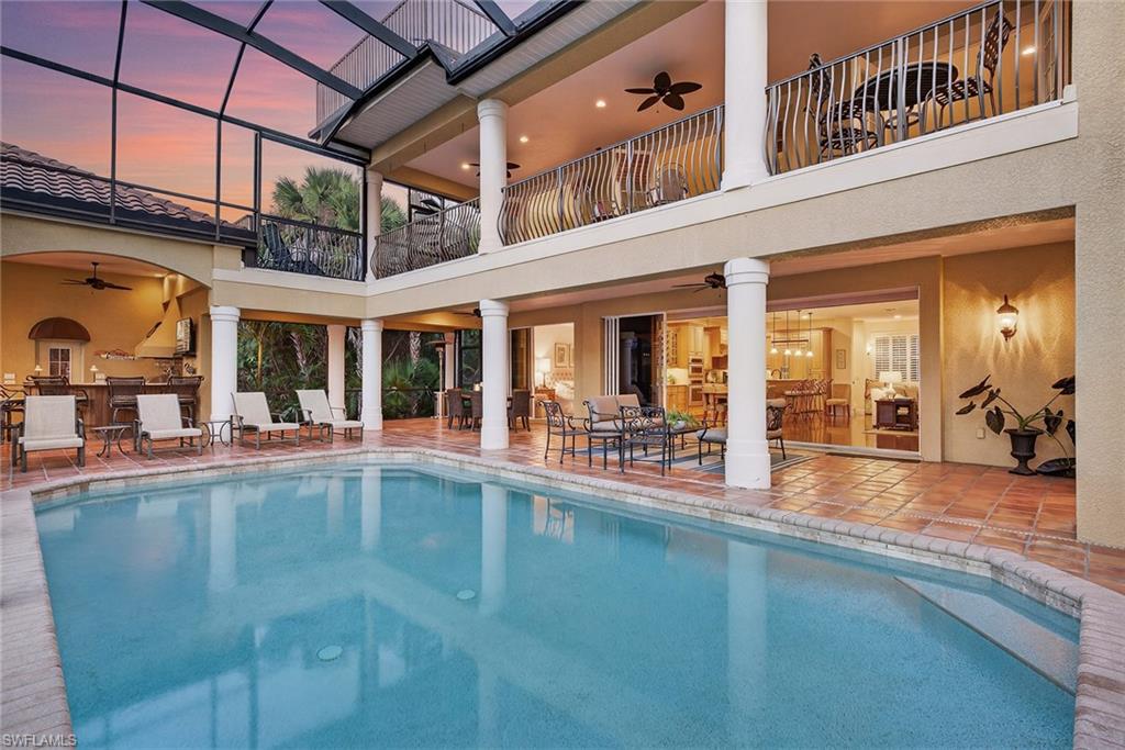 An exclusive opportunity awaits in Naples award-winning, amenity-rich Eagle Creek Country Club, a one-of-a-kind two-home family compound designed for multi-generational living and exceptional entertaining. Secluded on three private estate lots, approximately one acre of lush preserve, this seven-bedroom, 8.5-bath estate offers more than 6,000 square feet under air and an additional 6,000 square feet of outdoor living space. Two distinct residences are connected by a breezeway bordering a lushly landscaped front yard and surrounded by resort-inspired amenities that create a private oasis. The outdoor experience is defined by two heated pools and a spa highlighted by authentic Saltillo tile, multiple gathering areas and expansive lounging spaces ideal for hosting events, family celebrations or relaxing in total privacy. The main residence features a gourmet kitchen with premium stainless-steel appliances, granite surfaces and a breakfast bar that opens to an elegant dining area. A study transitions to a screened solarium, while a detached primary casita suite with a full en-suite bath offers French doors that open directly to the pool. A custom entertainment center, wet bar and open concept living spaces complete the home’s effortless flow for entertaining. The secondary residence is designed for guests or extended family, showcasing an expansive great room with a gas fireplace, a chef’s kitchen with granite island, first first-floor bedroom and full bath with walk-in closet and an additional three primary-sized bedrooms, each with their bath. Outdoor living continues with a fully equipped kitchen and tavern, poolside casita, pergola with fire pit, sky-deck observatory, four-car garage and tropical landscaping. Purpose-built as a private retreat, this distinctive estate combines space, privacy and sophistication within one of Naples desirable golf communities. Full golf membership is available. Eagle Creek’s recently reimagined clubhouse offers premier dining, fitness and social amenities, elevating the lifestyle experience to resort-caliber living.