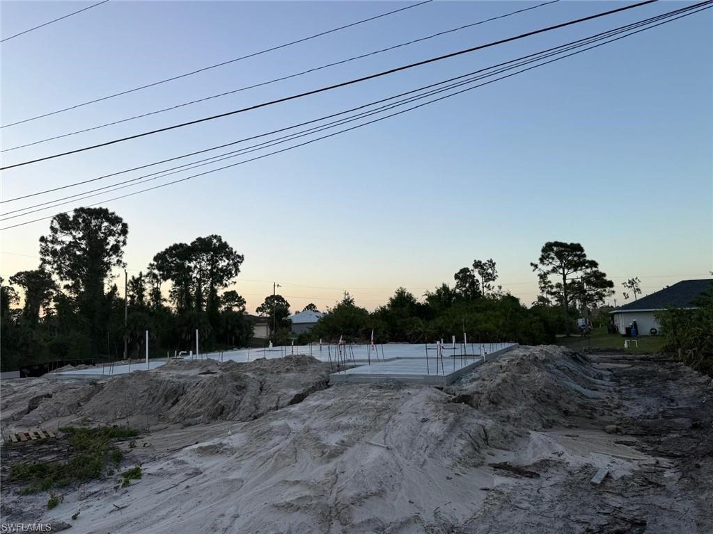 Prime duplex lot in Lehigh Acres just one block off SR-82 with quick access to Fort Myers. This is a shovel-ready opportunity with approved plans for a 6 bed / 4 bath duplex, impact fees already paid, and major construction progress completed—including pad, foundation, and plumbing rough-in. Save months of time and significant upfront costs. Perfect for investors or builders looking to step in and finish a high-demand income-producing property in a rapidly growing area.