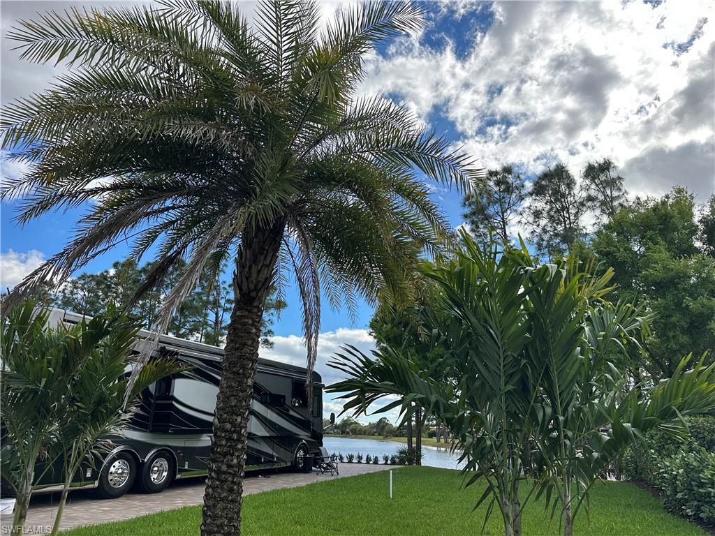 Your piece of paradise awaits in the highly desirable Golden Palms Luxury Motorcoach Resort. This fabulous Lakefront lot with an extra-large paver pad and privacy created by the tropical landscaping is ready for you to pull in and start enjoying the glorious SWFL sunshine. You will have plenty of space to park, Stacker trailers (painted to match the coach) or additional vehicles, right on your own paver pad. The 55X110 lot has room enough to add a coach cabana, outdoor kitchen, & even a pool, either now or in the future. Your warm winter dreams can come true here on Golden Palms Lot 26! The resort provides you with a stunning clubhouse, outdoor grills, saltwater pool, hot tub, sauna, and exercise room. There are plenty of activities for everyone and every interest including pickleball, cornhole, fishing pier, kayaks, paddleboats, darts, poker, board games, books, puzzles, and a 1-acre dog park for your furry friends. The resort is located on 54 acres with a 22-acre lake for catch and release fishing. You will be surrounded by nature, yet only a short drive away from restaurants, shopping, parks, golf, airport, Baseball Spring Training Stadiums, and SWFL Beaches.