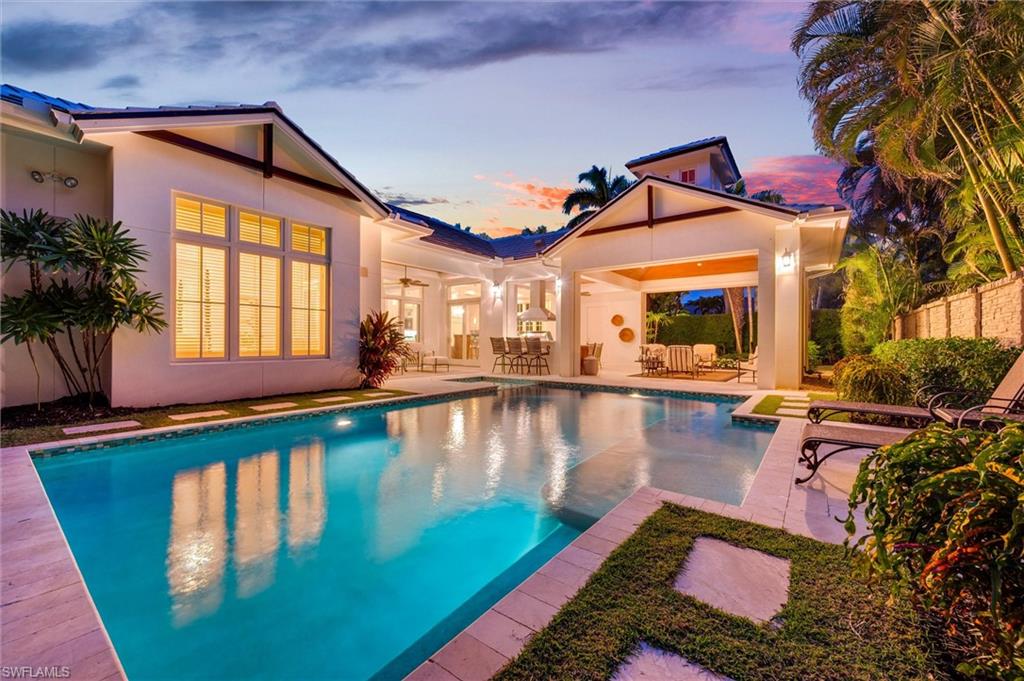 In the heart of the Moorings sits a picture-perfect single story home on a .36 acre southeast private corner lot. Prepare to be in awe with the attention to detail! Filled with natural light, the open floor 3933 under a/c, 5,473 total square foot plan is an ideal and manageable living space with a great flow. An innovative design with a one-of-a kind dramatic cupola featuring 4 bedrooms, 4 full baths, 2 half baths, a study, 3 car garage, gas heated pool and spa, an intimate outdoor living space and a lushly landscaped private side yard perfect for pets. Exceptional craftsmanship is found throughout the home with extensive custom millwork and moldings and beautifully stained and painted cypress tongue & groove vaulted ceilings. Fireplaces, a summer kitchen with a Viking grill, and remote-controlled screening and shutters make the outdoor space cozy and perfect for entertaining. The spectacular oversized gourmet kitchen offers Wolf, Bosch and Sub-Zero appliances as well as custom maplewood cabinetry, exotic quartz countertops, an expansive working island and butler’s prep area with full pantry. Extremely striking are the handcrafted European white oak hardwood floors, magnificent lighting fixtures, chandeliers and wall sconces, and the carefully selected stones and natural materials – marble, onyx, quartz, granite, and shell stone – adding warmth to the spaces. A professionally interior designed home, extraordinarily beautiful, and offered turnkey with luxurious custom furniture, original commissioned artwork, sculptures, fitness equipment, fine china, exquisite accessories, and home audio/visual throughout. Other special and mechanical features include two 2022 Lennox HVAC's with an 8 duct-zoning system and digital thermostats in every room; two tankless water heaters; 2022 gas pool heater & pump; 500 gallon propane tank; and a professional landscape design! Every detail of the home is simply perfect and only requires a discriminating buyer with a suitcase. No weather-related insurance claims, and no water damage. Location, location, location! Within one-half mile to Moorings Private Beach, an exclusive amenity privileged to this residence, and just moments from the new iconic Four Seasons Resort. Enjoy world-class dining and boutique shopping along 5th Avenue, Third Street, and Venetian Village, with top-rated hospitals, scenic parks, premier golf courses, and full-service marinas all conveniently nearby.  Come fall in love with paradise!