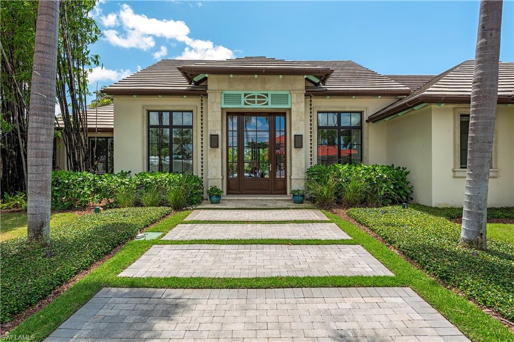 Step into luxury with this meticulously crafted home, a masterpiece designed by renowned Stofft Cooney Architects. Nestled in a serene setting, this stunning property boasts 4 bedrooms and 3 baths, offering unparalleled comfort and elegance. Only a portion of the original slab from 1977 remains after this home’s remarkable transformation in 2014. The details of this home showcases exquisite craftsmanship and thoughtful design. From the stabilization of the helical pilings, to the concrete masonry, steel, and poured concrete tie beams of the exterior walls, to the Anderson 400 series laminated windows and French doors, every element is chosen for its quality and durability. Outside, relish in your own private oasis, complete with a saltwater pool, spa, gas fire pit, and lanai with motorized bug screen and solar shade. The pool deck features sand-set Turkish limestone, while the driveway boasts concrete pavers with turf inserts. A 1,000-gallon propane tank buried in the front yard supplies gas to the cooktop, Evo grill, fire pit, pool/spa heater, and more. The elevated rear yard steps down to dock with Aztec decking, and a 13,000 pound boat lift with controls. The interior is equally impressive, with custom cabinets, engineered white oak wood flooring, and Lutron low-voltage lighting throughout. The kitchen and bar are outfitted with Sub Zero and Wolfe appliances, exotic granite, and quartz countertops, perfect for the discerning chef. En­ter­tain­ment and com­fort are seam­lessly in­te­grated with a wet bar, and smart home sys­tem by Sa­vant that con­trols the sur­round sound au­dio, TV’s, light­ing, motorized shades, and security cameras throughout. Luxury meets functionality in every aspect of this home, from the custom-designed ceilings and millwork to the motorized black-out shades in the primary suite. You can rest assured here - a whol­e hous­e gen­er­a­tor and su­pe­rior el­e­va­tion keep this prop­erty high and dry and never wi­thout power dur­ing a storm. FEMA policy less than $1k last year and can be assumed by the Buyer. This home offers the ultimate in modern living, where every comfort and convenience has been carefully considered.