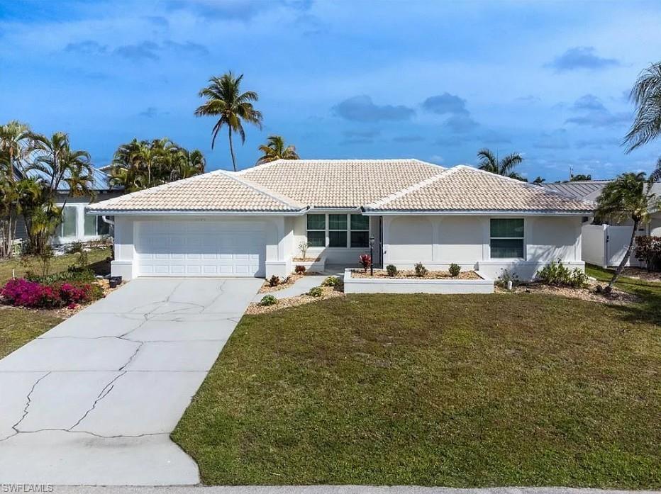 TURNKEY FURNISHED WITH DIRECT GULF ACCESS! Prepare to be captivated by this stunningly upgraded, split-floor-plan waterfront pool home in the prestigious Punta Gorda Isles community. Offered fully turnkey with the high-quality modern furnishings and contemporary decor included, this 3-bedroom, 3-full-bathroom residence is completely move-in ready. The extensively improved interior features a chef-inspired kitchen with premium quartz countertops, white shaker cabinetry, stainless steel appliances, and a centralized island seamlessly overlooking a bright dining area and a comfortable living space with premium leather seating. Both guest rooms are private and spacious, while the master suite features a spa-like bath with bold geometric tilework. Step outside to your private oasis, where a pristine pool and concrete dock sit on a wide canal offering a fast, direct route with no fixed bridges to Charlotte Harbor and the Gulf of Mexico—making it an absolute boater’s dream