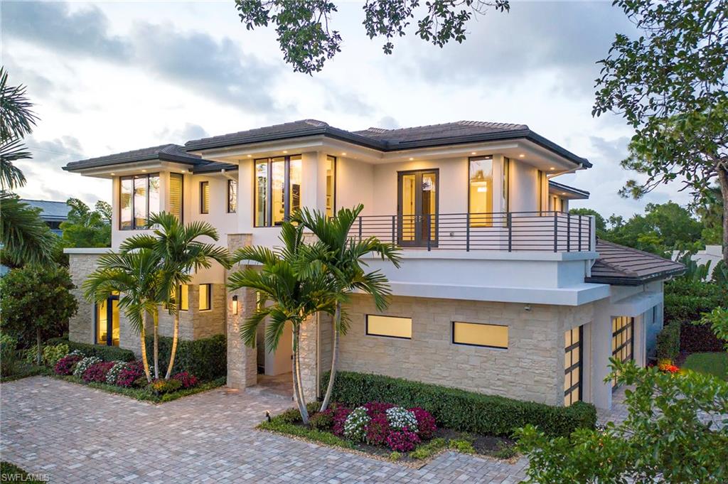 H.13061 - Situated among the huge banyan trees and mature landscape of Coquina Sands, this rugged yet modern home delivers warmth and sophistication while providing an unmatched living experience. The uniquely shaped lot offers a huge side yard with ultimate privacy and allows for a 60’ Resort-style lap pool with a fountain wall. Spend warm afternoons relaxing on multiple pool decks and entertain family and friends with the well-appointed chef’s summer kitchen, and outdoor dining/living areas equipped with a Bioflame fireplace and electric screens and hurricane shutters. Designed by the world-renowned Kronen Design Company this custom built home’s interior includes: a Mahogany entry door, over-sized porcelain tile and wide board oak flooring, wood-accented ceilings with LED accent lighting, Control 4 automation, 6 security cameras, and a temperature controlled wine room with a changing LED bartop serves as the home's centerpiece. Take the glass elevator to the second floor where you’ll find two guest suites, a gracious loft area, a study, and an expansive master suite. The master suite includes: steam shower, his and hers Toto toilets, marble floors, and granite counter-tops.