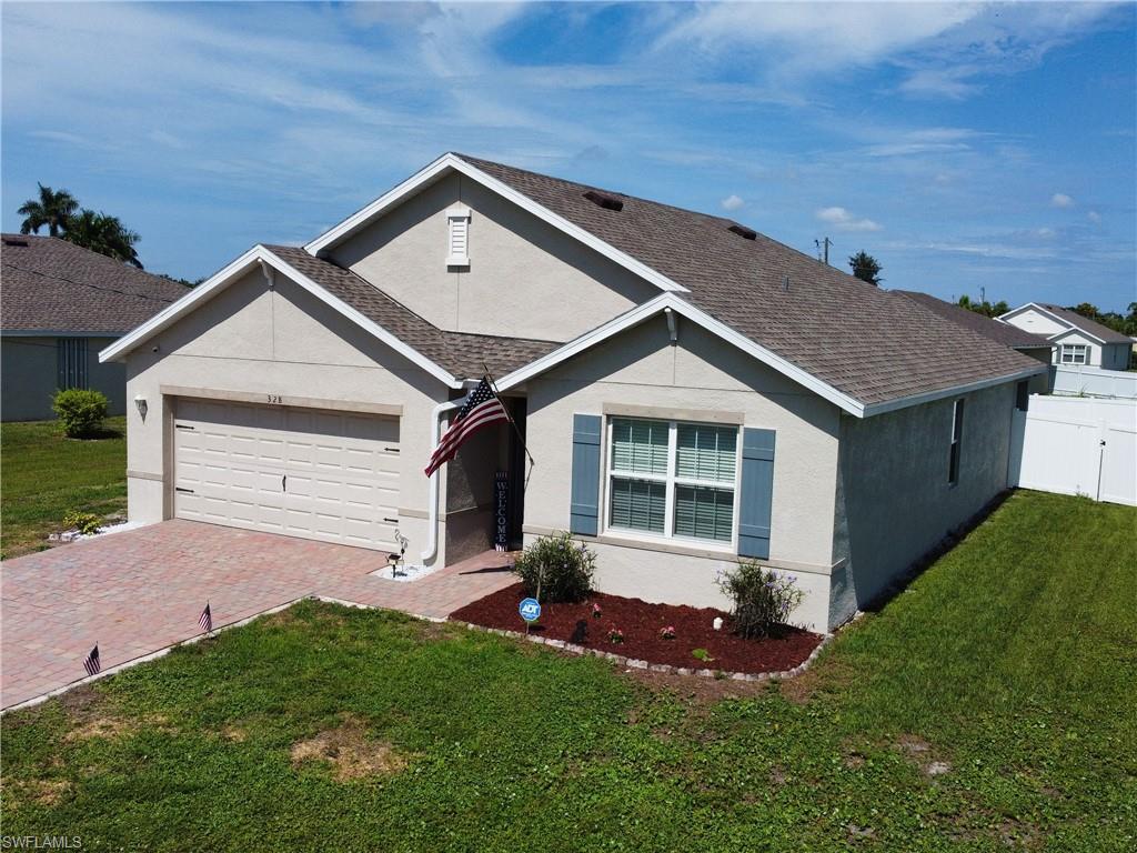 Welcome to this move-in-ready 4-bedroom, 2-bath home offering 1,828 square feet of open-concept living in one of Southwest Cape Coral's desirable neighborhoods. With city water and sewer assessments already paid, this home delivers comfort, convenience, and exceptional value. Inside, you'll find a bright and spacious great room, an open-concept kitchen with a breakfast bar, and a dining area off the great room. The kitchen features wood-like cabinetry, quartz countertops throughout the kitchen and bathrooms, stainless steel appliances, a large pantry, and tile flooring in the main living areas with soft carpeting in the bedrooms. The primary wing offers a spacious master bath with dual sinks, a walk-in shower, a walk-in closet, and a linen closet. The interior laundry room includes a washer and dryer, making everyday living easier. Modern Smart Home features include a smart thermostat, smart door lock, video doorbell, smart garage controller, and Deako smart switches, giving you added security and convenience at your fingertips. Step outside to a fully fenced backyard with white vinyl privacy fencing—perfect for children, pets, or simply enjoying your own private outdoor retreat. There's plenty of room to add a pool, create a garden, or design the backyard of your dreams. A paver driveway, paved open lanai, automatic sprinkler system, power inlet box (for generator), metal hurricane shutters, night lighting and garage door opener complete the package. Conveniently located near shopping, restaurants, schools, parks, and major roadways, this home is ideal for full-time residents, seasonal owners, or investors looking for a property with lasting value. Don't miss your opportunity to make this Southwest Cape Coral home your own.