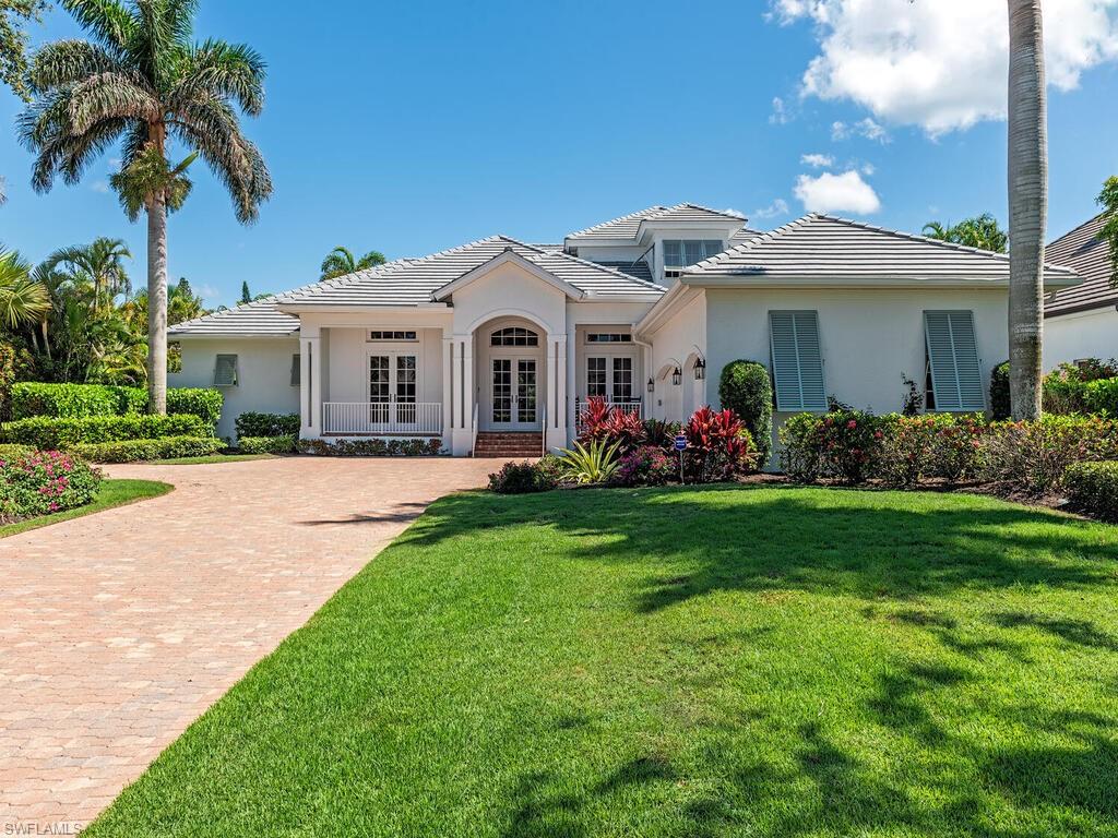 Exceptional completely remodeled custom-home, located in an X-flood zone in the Moorings. Perfectly positioned on a sought-after oversized southern exposure lot just minutes from the Moorings' exclusive private beach access. A welcoming foyer leads to a south-facing covered veranda, a pool and spa surround, and a beautifully landscaped, fenced garden. The home features a formal dining room, Chef's kitchen complete with incredible La Cornue induction range, custom hood, quartz countertops, Butler's pantry and additional prep sinks. This home boasts a spacious private study with built-in bookshelves, and a light-filled great room with vaulted ceilings and a gas-fed fireplace. The expansive veranda includes multiple seating areas, an outdoor kitchen, and direct access to the pool, enhancing the splendid indoor-outdoor lifestyle. The generous primary suite includes to large custom-fitted closets, and a spa-like bathroom with dual sinks, jetted soaking tub, separate shower, and more. Upstairs, two ensuite bedrooms each enjoy access to a shared covered balcony. Additional features includes a whole-house water filtration system, a five hundred gallon in-ground gas tank, fireplace, a 22KW whole-house generator, solar and electric pool heaters, impact-resistant windows and doors, New roof, a three-bay garage, and many recent updates. The Moorings offers serene Gulf and beach access in a tranquil, well-established community setting.