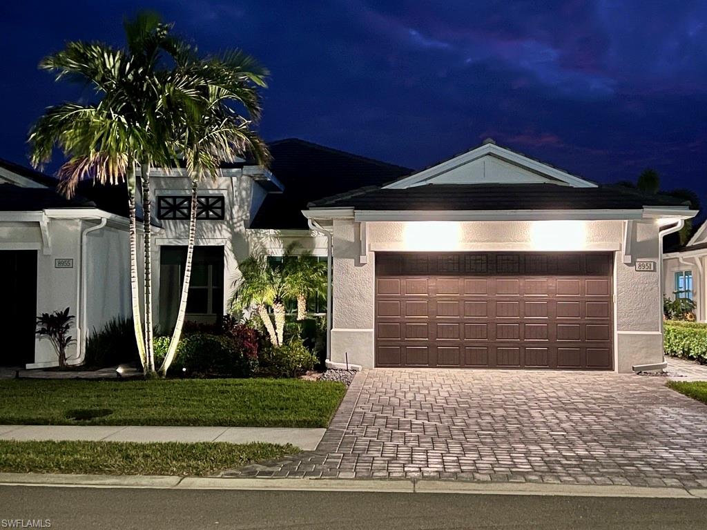 This home is under contract with a settlement contingency, but showings are still welcome and we are accepting backup offers - your opportunity may still be here! Welcome to effortless Florida living in the gated community of Azure at Hacienda Lakes. This beautifully maintained 2-bedroom, 2-bath home offers 1,645 square feet of thoughtfully designed living space and is being sold fully furnished with high-end pieces from Pottery Barn and West Elm. Step inside to find wall-to-wall tile flooring, detailed crown molding and wainscoting, and a neutral palette freshly repainted throughout. The open-concept layout flows seamlessly to a covered lanai overlooking a tranquil lake—your personal backdrop for morning coffee or evening relaxation. Both the primary and guest bedrooms feature custom-built walk-in closets, thoughtfully designed and ready for your clothes, shoes, and accessories. Additional storage upgrades include a built-in hallway pantry and generous cabinetry in the laundry room, which is also pre-plumbed for a utility sink. Other highlights include a Tesla charger in the 2-car garage, Hunter Douglas plantation shutters, upgraded washer and dryer, and smart exterior and landscape lighting systems on timers. Located in a vibrant gated community with resort-style amenities—clubhouse, pool, fitness center, tennis, and more—this home offers the ideal blend of style, comfort, and convenience. Just pack a bag—this home is fully equipped and move-in ready. Whether you're searching for a seasonal escape or a full-time residence, this turnkey lakeview villa checks every box.