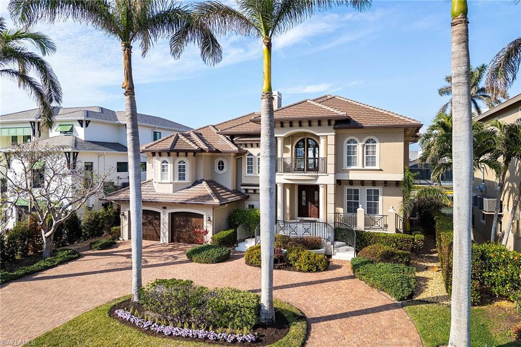 Discover unparalleled luxury in this exquisite bayfront property, offering direct gulf access and over 3,500 square feet of refined living space. The home features four generously sized bedrooms, four full baths and multiple living areas including separate living, dining and family rooms, dual closets and vanities in the primary suite, and volume ceilings and custom millwork all designed for comfort and style. The newly remastered custom chef’s kitchen boasts a large center island, temperature-controlled wine storage, stainless steel appliances, pull-out shelving and elegant quartz countertops. Seamlessly transitioning from interior to outdoors, the expansive living areas open to a beautifully designed outdoor space complete with summer kitchen, ideal for dining and entertaining. Just a short distance away, enjoy the heated pool and spa. Whether you’re fishing or relaxing under the sun, the large dock with a 10,000-pound boat lift provides everything you need for waterfront living. The ground level offers a two-car garage and two sizable storage areas, ideal for storage or a workshop for the handy homeowner.