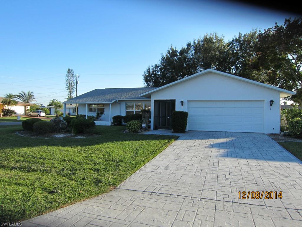 Very well kept 3/2 in the Country Club neighborhood across from gulf access properties.  This large sought after corner lot has southern exposure with plenty of room for a pool.  New roof and a/c in '05, new windows in '06 and a new water heater this year.  Large lanai for entertaining with access to the bath.  All assessments are in and PAID