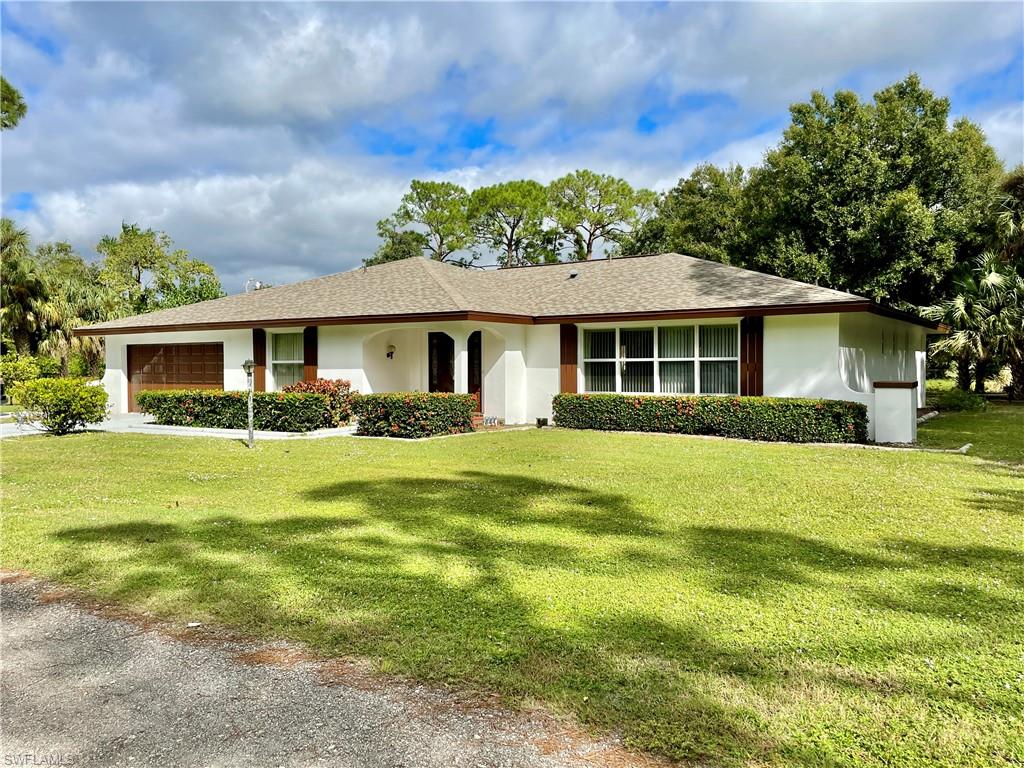CHARMING AND UNIQUE HOME ON 3/4 ACRES IN FT. MYERS SHORES/BUCKINGHAM AREA! 3 BR / 2 BA / 2 Car Garage home features a split floor plan with 2,640 SF under air. Bonus room with access from garage can be used as a workshop, fitness room, office, or small guest room. Kitchen has lots of cabinet space and a large pantry for additional storage. Spacious laundry room with more cabinet space. ROOF JAN 2020. AC 9 1/2 YRS. EXTERIOR PAINTED 2021. CITY WATER AND SEPTIC. IMPACT WINDOWS front and side of house. Master bedroom with large master bath with dual sinks and walk-in shower. Rear and sides of property are fenced and includes a guava tree, valencia orange tree, lime tree, and ponderosa lemon tree. Large pavilion is great for gatherings and additional outside seating area. Concrete pad for RV or boat parking. Shed. Brick BBQ smoker/oven on another concrete pad. Marina with docks and fuel only a short drive down the road. Private road. Enjoy quiet lounge time on the expansive screened lanai. Home needs updating but has great potential! Don't miss your opportunity to own a house on a great piece of property near the Caloosahatchee River. Schedule your private showing today!