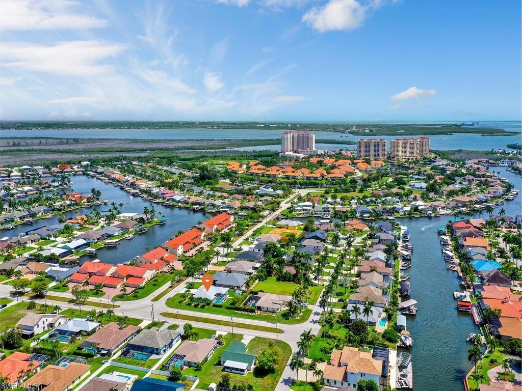 Welcome to the highly sought-after Rose Garden neighborhood in desirable Southwest Cape Coral! Opportunities to own a home of this caliber are rare—and when they do hit the market, they don't last long. This beautifully maintained pool home is perfectly situated on a spacious corner lot and offers over 2,100 square feet of living space with 3 bedrooms, 2.5 baths, and a private office/den. Recent updates include fresh interior and exterior paint, new lighting and ceiling fans, plantation shutters, and numerous thoughtful upgrades throughout.
Designed for both comfortable living and effortless entertaining, the functional floor plan features formal living and dining rooms, along with a large family room overlooking the lanai and pool area. The open-concept kitchen showcases granite countertops, stainless steel appliances, a stylish glass tile backsplash, coffee station, built-in desk, and abundant cabinetry for exceptional storage. The spacious owner's suite offers dual vanities, a walk-in shower with glass enclosure, and a large walk-in closet. Guest bedrooms are privately located on the opposite side of the home, providing comfort and privacy for family and visitors alike. Multiple sliding glass doors open to the expansive covered lanai and screened pool area, creating the ultimate indoor-outdoor Florida lifestyle. The pool was recently refinished in 2023' and features an electric heater, pool bath and screened enclosure. The fully fenced backyard is a tropical oasis with brick paver walkways, mature palm trees, lush landscaping, and complete privacy. An additional storage shed provides convenient space for gardening tools and outdoor equipment. The 2-car garage is equipped with epoxy floors, overhead storage racks, a hurricane-rated garage door & opener, and Halo whole-home water filtration system. For added peace of mind, the home is protected by hurricane shutters throughout, including electric roll-down shutters on the front entry and lanai. This property has never flooded and includes a transferable flood insurance policy currently at just $1,886 annually. Ideally located within walking distance of Rotary Park and Tarpon Point Marina, enjoy nature trails, fitness stations, a dog park, waterfront dining, boutique shopping, galleries, and the scenic marina promenade. Home is Beautifully Decorated and is Offered Fully Furnished! This exceptional property truly offers the best of Southwest Florida living. Schedule your private showing today and experience everything this remarkable home has to offer.