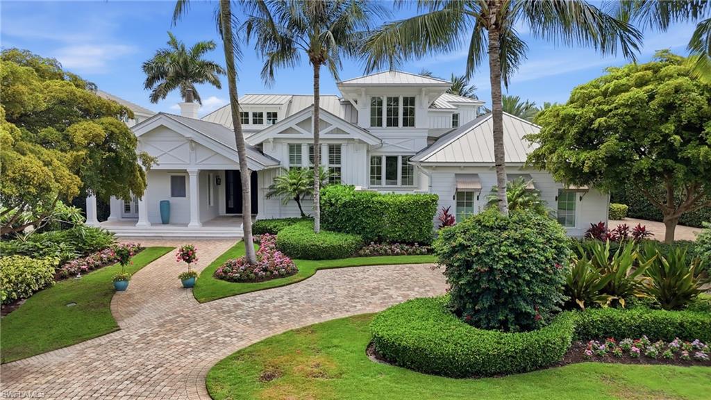 A boater’s paradise in the heart of Aqualane Shores on prestigious 4th Street South, showcasing wide water views across Aqua Cove and direct Gulf access along one of Naples’ most coveted waterways. This exceptional waterfront estate features 4 spacious bedrooms plus a private office, 4 full baths, 2 half baths, and a thoughtfully designed living space created for indoor-outdoor living. Fully pocketing glass doors connect the gourmet kitchen and expansive great room to the covered lanai, pool, spa, and waterfront areas, creating effortless flow for entertaining and everyday living. The kitchen is appointed with premium appliances, custom cabinetry, designer finishes, and an oversized island ideal for gatherings. The luxurious primary suite features tranquil waterfront and pool views, dual custom walk-in closets, freestanding soaking tub, oversized walk-in shower, paired marble vanities, skylight, outdoor shower and a private terrace with motorized screens. Additional highlights include a whole-house generator, standing seam metal roof, 3-car air-conditioned garage with room for lifts, motorized lanai screens, wide-plank Acacia walnut flooring, tray and coffered ceilings, Lutron lighting system, Sonos surround sound, and Andersen impact-resistant windows and doors. Resort-style outdoor amenities include a gas-heated saline infinity-edge pool and spa, expansive lounge areas, and a completely rebuilt ‘grandfathered’ boathouse with covered boat slip, lifts, and rooftop sun deck. Ideal for enjoying the Naples waterfront lifestyle and breathtaking sunset skies. Built by Hemmer Construction, designed by Jeff Harrell Architects, and finished by LDL Interiors, this residence blends sophisticated architecture with refined finishes and exceptional craftsmanship. Cruise to the Gulf or walk to the beach in minutes while enjoying close proximity to fine dining, luxury shopping, and downtown Olde Naples.