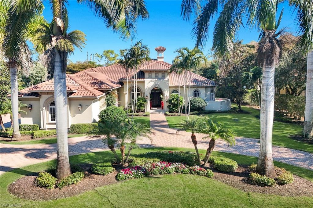 This exceptional residence on an Estate lot in Grey Oaks—Built in 2015 with Full Storm Protection—delivers refined architecture, gracious proportions, and effortless luxury living!  A stately entry sets the tone, opening to elegant formal living and dining rooms, beautifully enhanced by marble floors, a gas Fireplace and a notable Custom Service Center with wet bar and wine cooler—ideal for elevated entertaining.  At the heart of the home, the chef-inspired kitchen blends style and function.  The kitchen, equipped with a Wolf 6 burner Range, pot-filler, Micro and Wall Oven are accompanied by a 48” Sub-Zero Frig and Freezer, 2 in one Fisher Pakel Dishwasher, Appliance Garage, Mixer on a lift, Quartz counters and glass display cabinets.  All flow seamlessly with the breakfast area, family room, and media space, creating an inviting yet sophisticated gathering environment. The residence offers four bedrooms plus a private study, four full baths, a powder bath, and a dedicated pool bath. Three expansive guest suites with wood floors feature en suite baths, while the private Primary Wing serves as a true retreat, complete with a sitting area and a spa-inspired bath designed for indulgence.  The Study offers separation from the main living to provide privacy.  Outdoor living is nothing short of resort-caliber. The expansive pool deck features covered lounge and dining spaces alongside generous open patio areas for sunbathing and entertaining. The pool is highlighted by a sun shelf, spa, and cascading waterfall feature, creating a serene and luxurious outdoor oasis framed by lush surroundings.  Additional highlights include an over-sized laundry room with abundant storage and a three-car garage with dedicated work area. Set within a distinguished golf course enclave known for its elegance and Unmatched Lifestyle Amenities, this residence offers a rare opportunity to enjoy privacy, scale, and sophistication in one of Naples’ most coveted settings.  Grey Oaks is singular in offerings with 3 Golf Courses, 2 Clubhouses, Resort Pool, Tennis Exhibition Center, Pickleball, and the one of a kind Wellness Center.  Located 10 minutes to the famed Old Naples restaurants, Waterside Shops and the upbeat Mercato.
