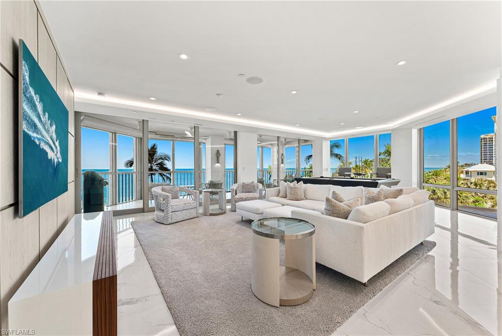 Beautifully renovated with spectacular views of the Gulf from nearly every room, this direct beachfront condo is one of a kind in the highly sought after Le Parc. With 4,000 square feet of living space, 4 bedrooms plus den and 4 full baths, the expansive floor plan is luxury beachfront living at its finest. Step inside the stunning kitchen, complete with backlit Cristallo quartzite countertops and a large center island, before making your way over to the seamlessly designed sit-in bar, a perfect space for hosting or just hanging out. A renovation that started from the studs, there is no lavish detail left behind including but not limited to a reimagined floor plan, sleek linear diffusers increasing the ceiling height, LED custom lighting, electric blinds throughout, custom SOHO cabinetry & so much more. Spend your evenings on the screened lanai; the sand as your backdrop while you grill on the infrared outdoor grill and stay cozy on cool evenings with the heaters on the ceilings. Residents and guests alike will feel right at home in this modern masterpiece. Le Parc residents and guests enjoy a beachfront oasis complete with a resort style pool, covered spa area, upgraded fitness room, 2 parking spaces and more.